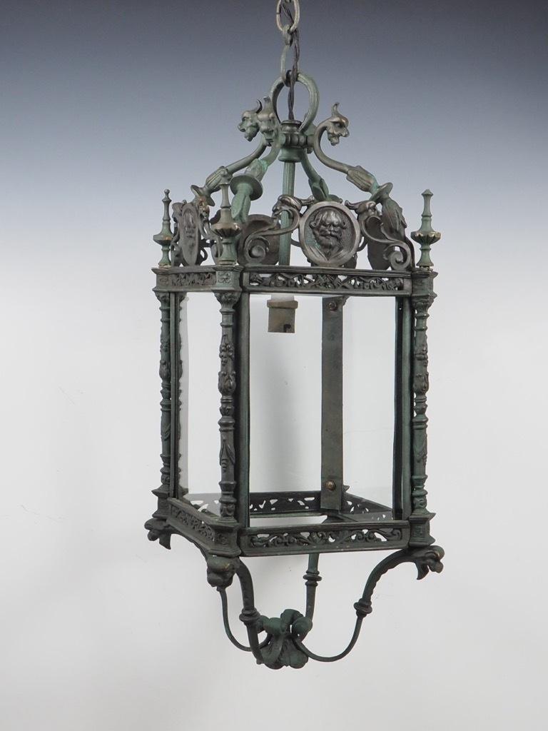English Grand Antique Bronze Hall Lantern with Verdigris is a stunning piece that exemplifies the craftsmanship of the mid-19th century, specifically crafted in the United Kingdom around 1850.

This exquisite lantern features a rich, solid bronze