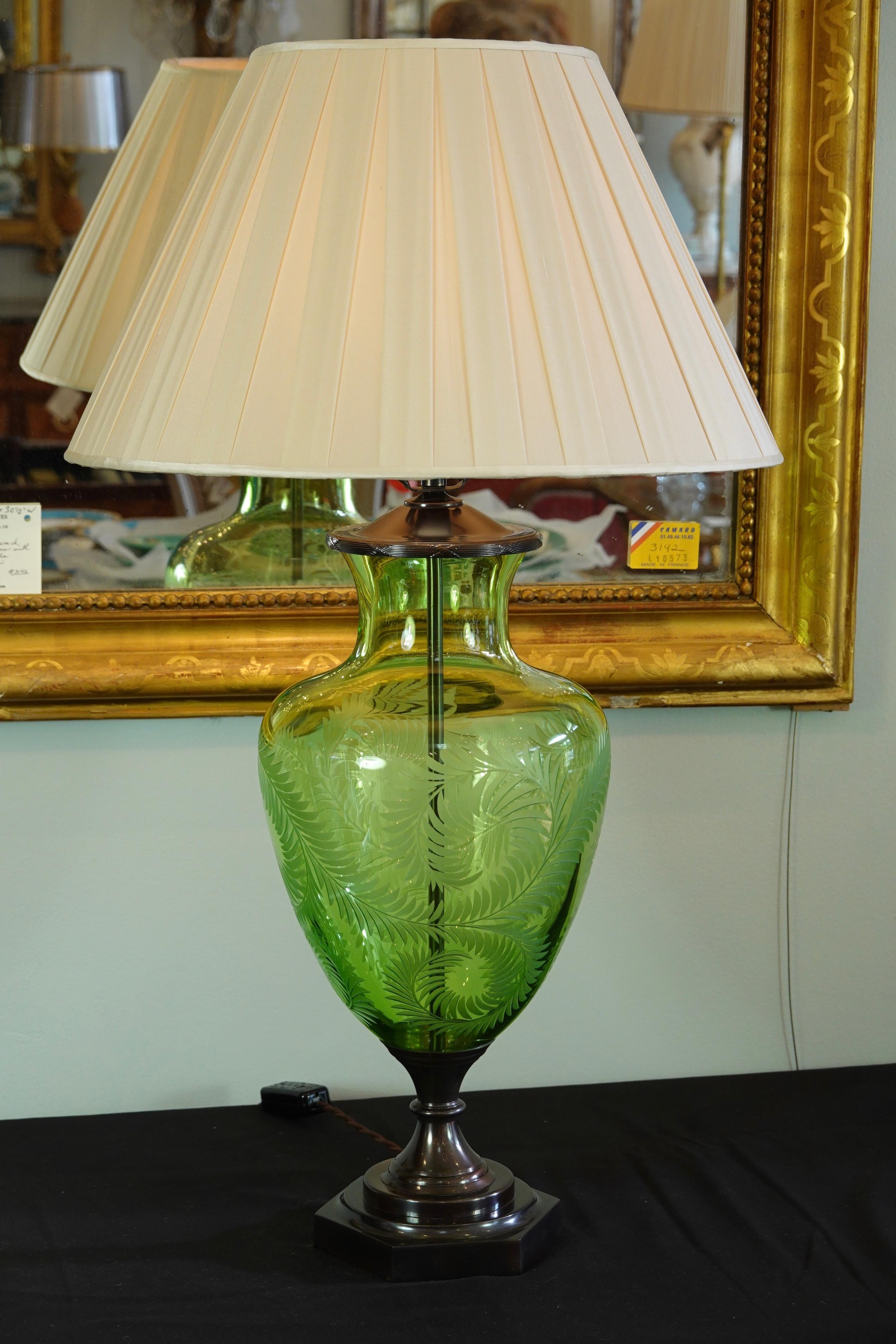 Light green crystal urn-form lamp with etched fern leafs design by Lucy Cope. The lamp was handmade in England and is wired for the US. The lamp features patinated bronze octagonal base and vase cap with reed and ribbon design. Included new pleated