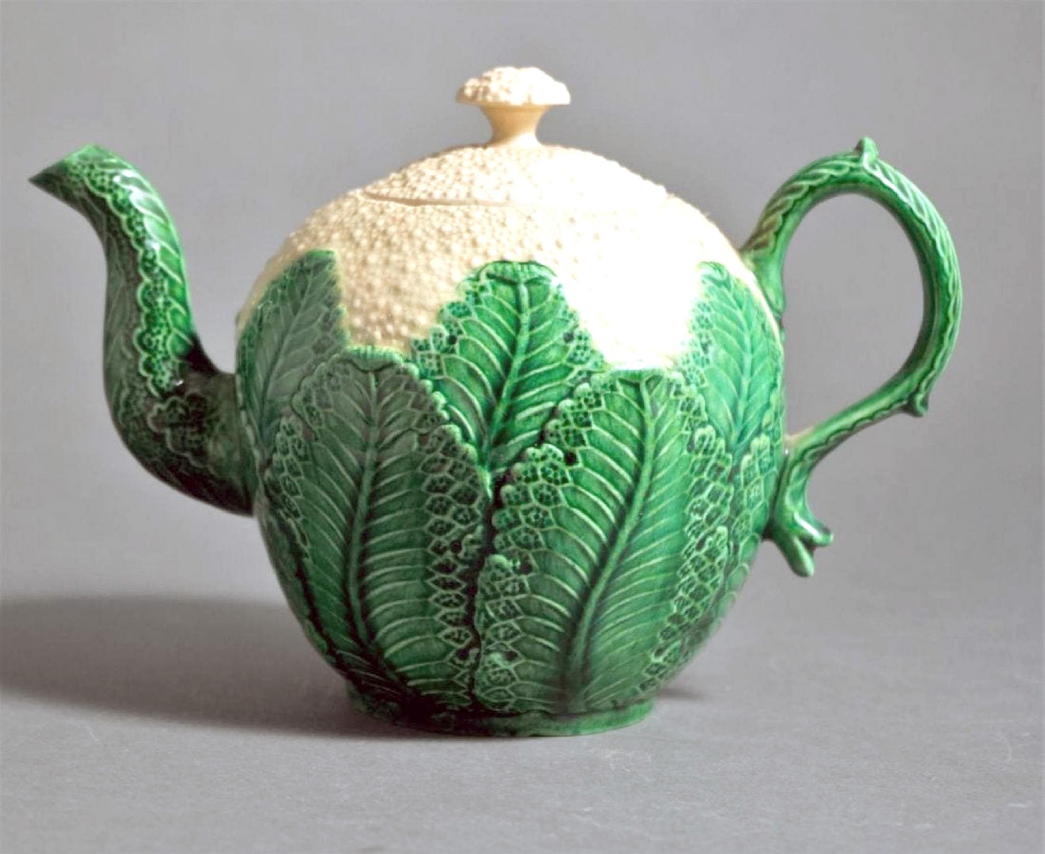 English green-glazed Creamware pottery cauliflower teapot and cover,
circa 1755-1775.

A creamware cauliflower teapot naturalistically molded as cauliflower florets above overlapping green-glazed leaves with molded spout and