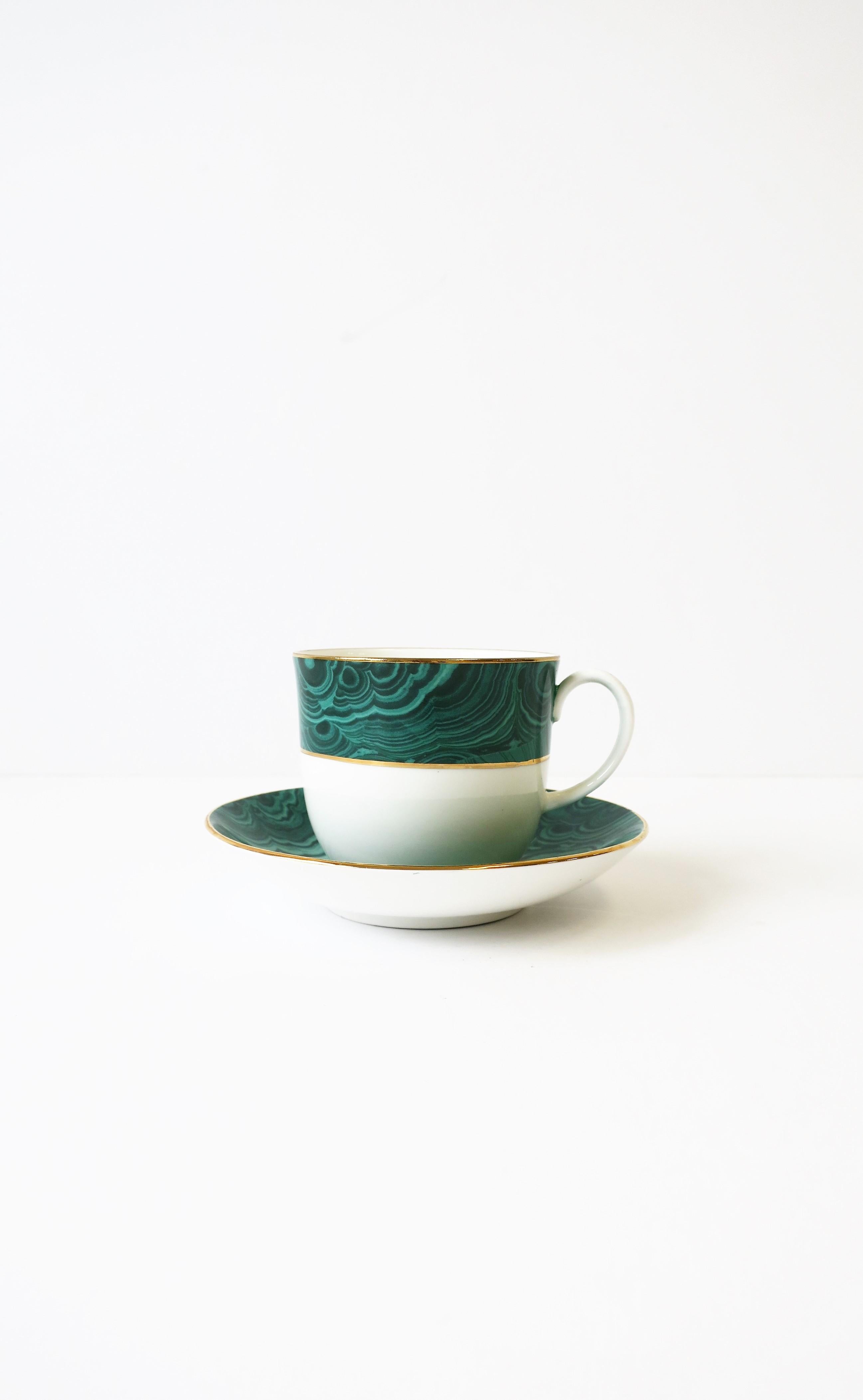 A beautiful English white porcelain coffee or tea cup and saucer with a green malachite design and a gold detailing on edge. Made in England. Two sets available, each sold separately as per listing.

Nesting tables show in images also available,