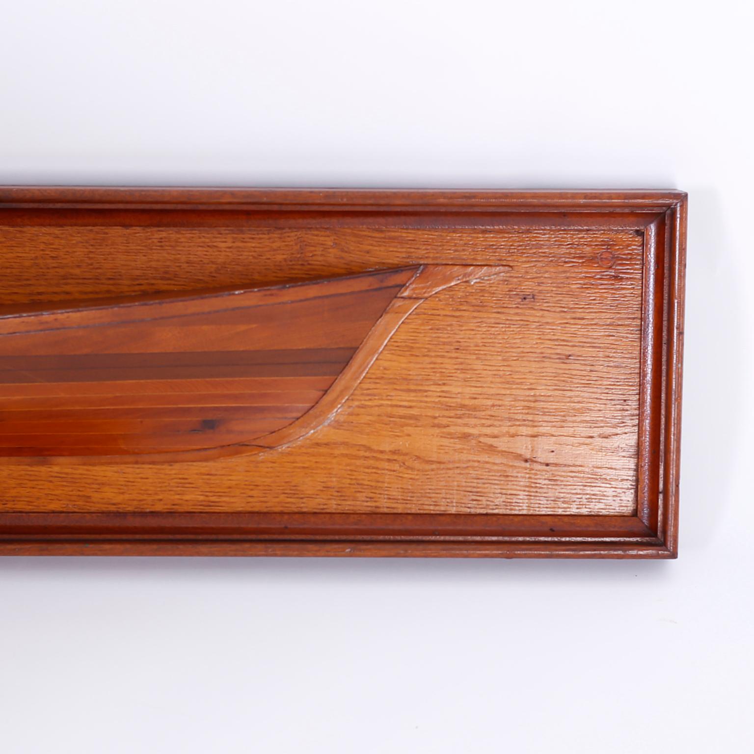Antique half haul boat model crafted in mahogany with a mahogany frame and presented on a red oak background.