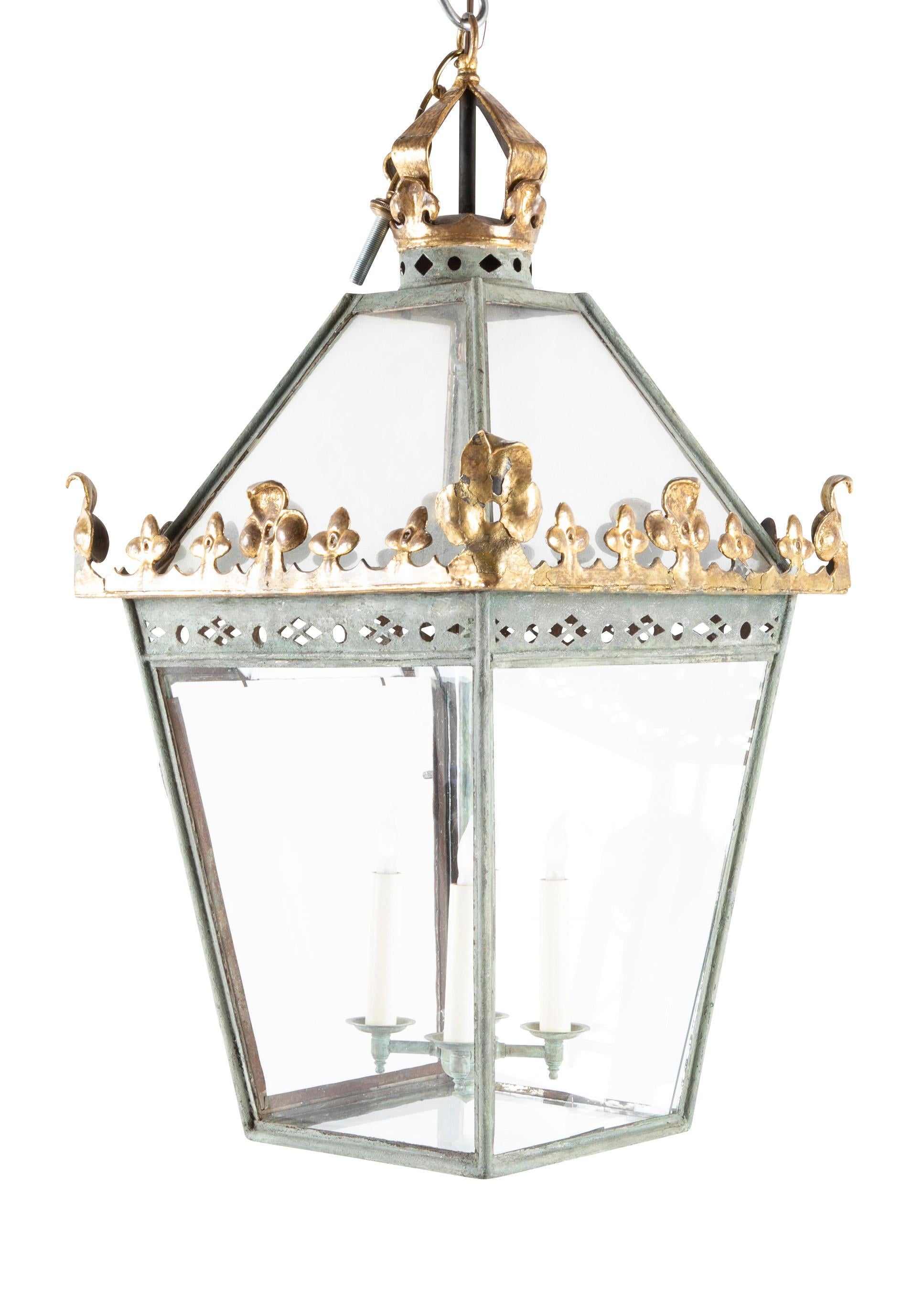 A parcel-gilt English tapered square metal lantern with original painted metal.