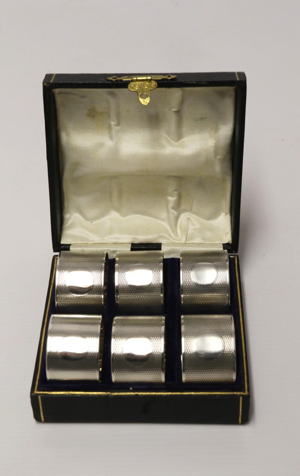 A set of six boxed silver Napkin rings. A good quality set of six engine turned heavy gauge silver napkin rings with circular pateraes for engraving initials. This fine set was made in Birmingham in 1919-1920 and is complete with original fitted