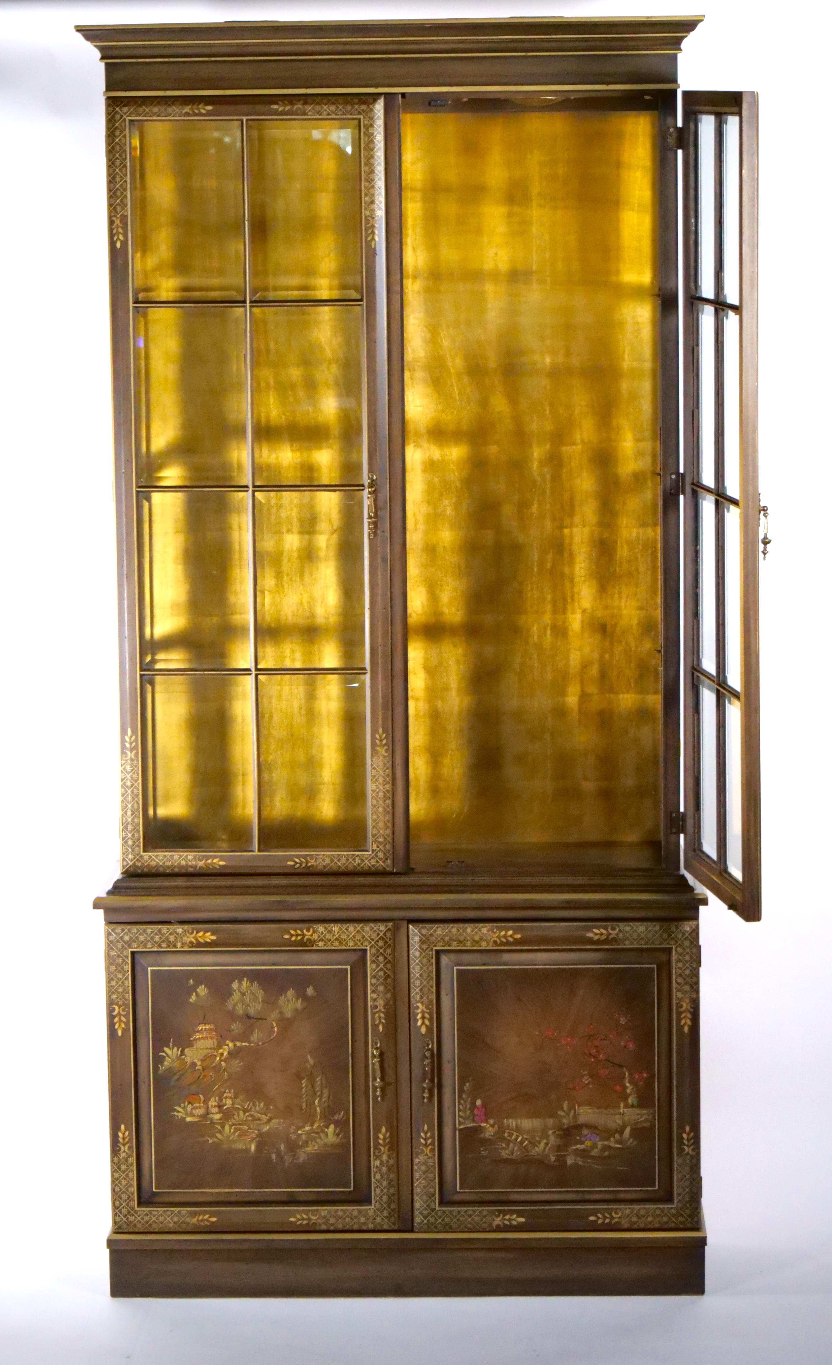 Beautiful English craftsmanship hand painted and decorated gilt chinoiserie display cabinet. This chinoiserie cabinet has Chinese Chippendale styling decoration scene and a vibrant gold interior backdrop. The backdrop appears to be hand painted.