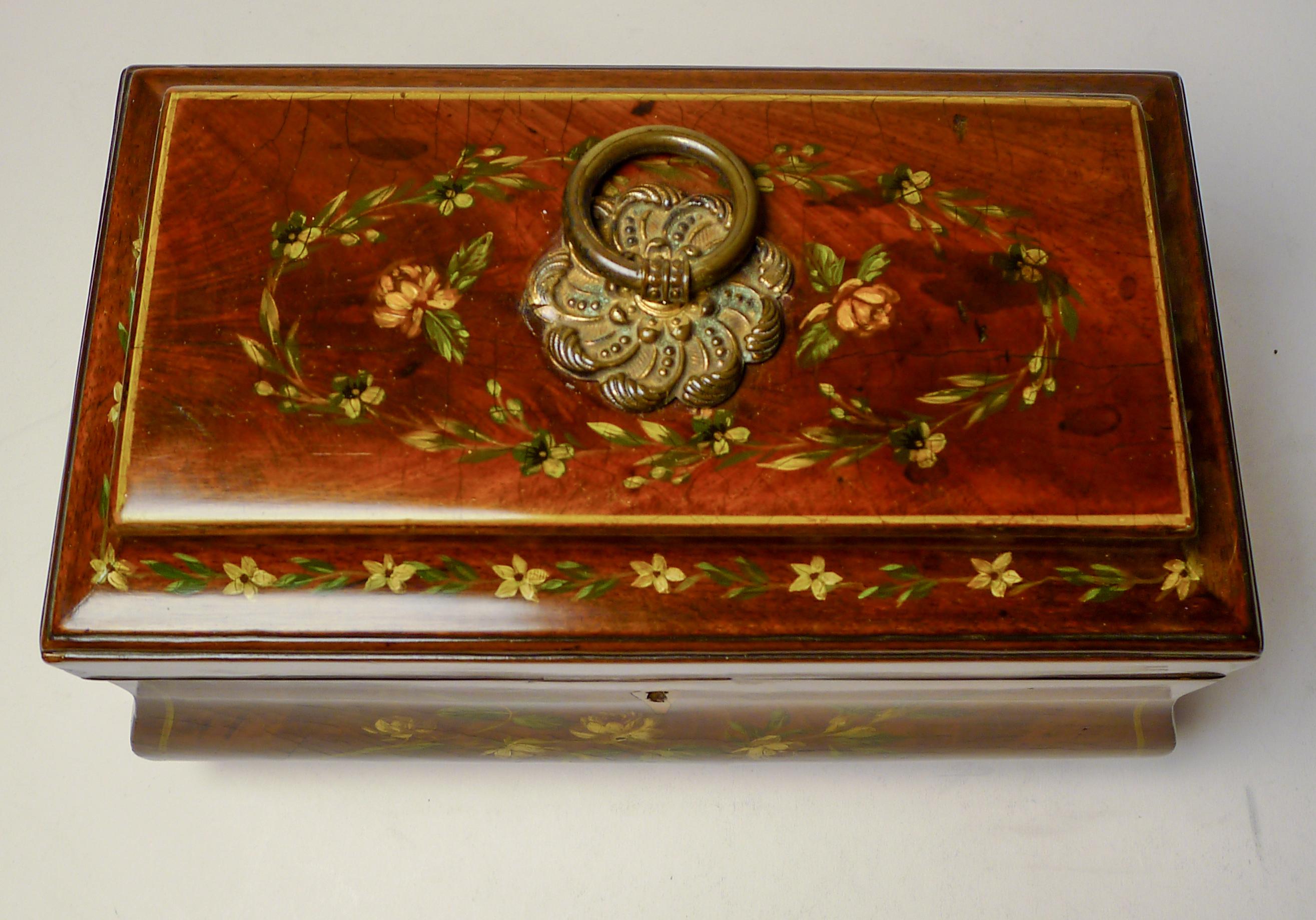 A really magnificent and pretty Regency tea caddy, the splendid shape having been beautifully painted on all sides with floral and foliate garlands, each panel framed.

The top retains it's original gilded ring finial which compliments the three