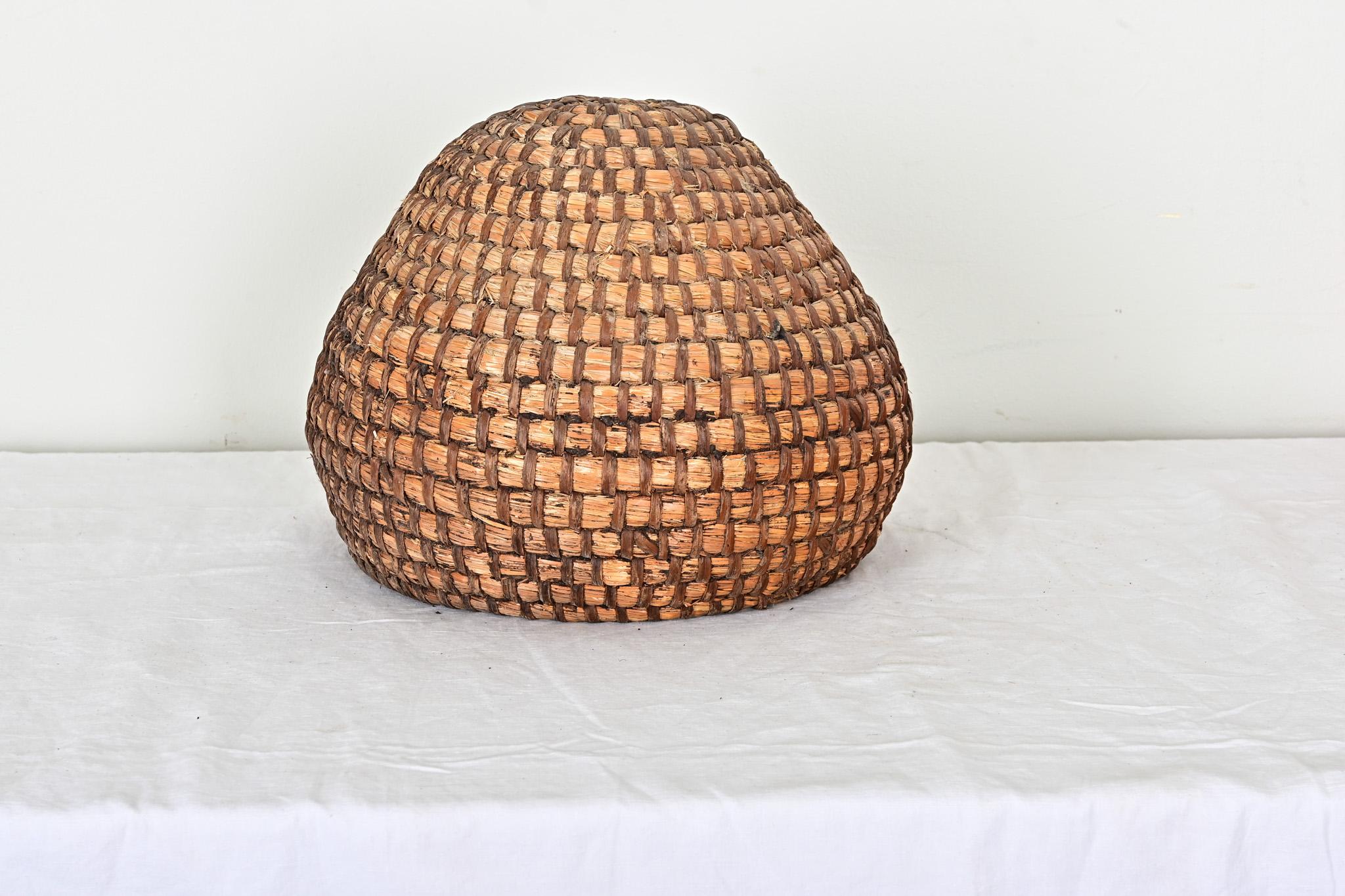 A lovely example of basketweaving skills, this late 19th century English straw bee skep, or temporary beehive, shows beautiful color and shape in tightly coiled fibers to mimic a hive. For centuries growers and farmers relied on skeps to encourage