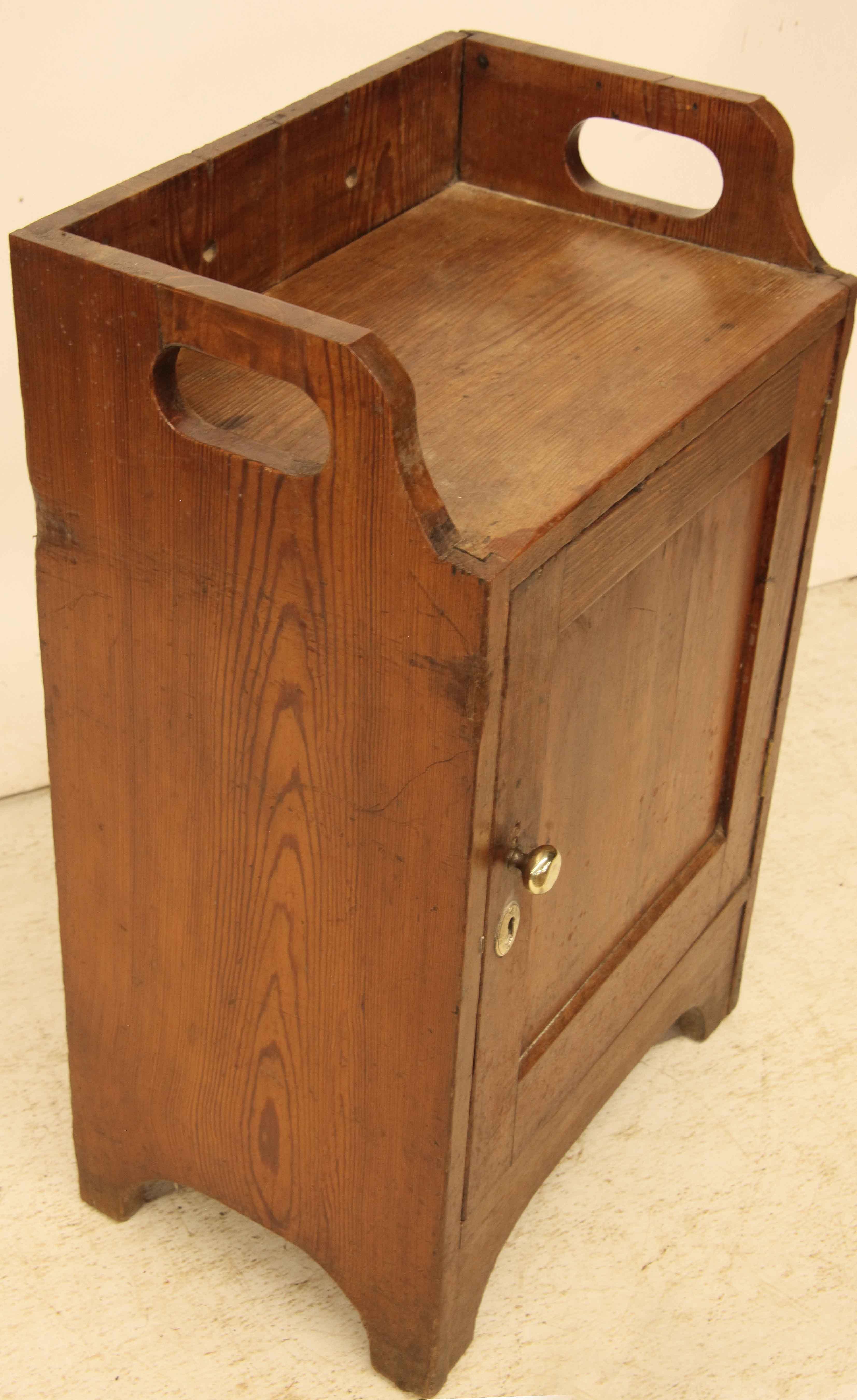English heart pine cupboard, with gallery around the top having cut out handles on the sides for carrying, single door with original brass knob opens to reveal interior with one shelf.  The surface height is 25.5''