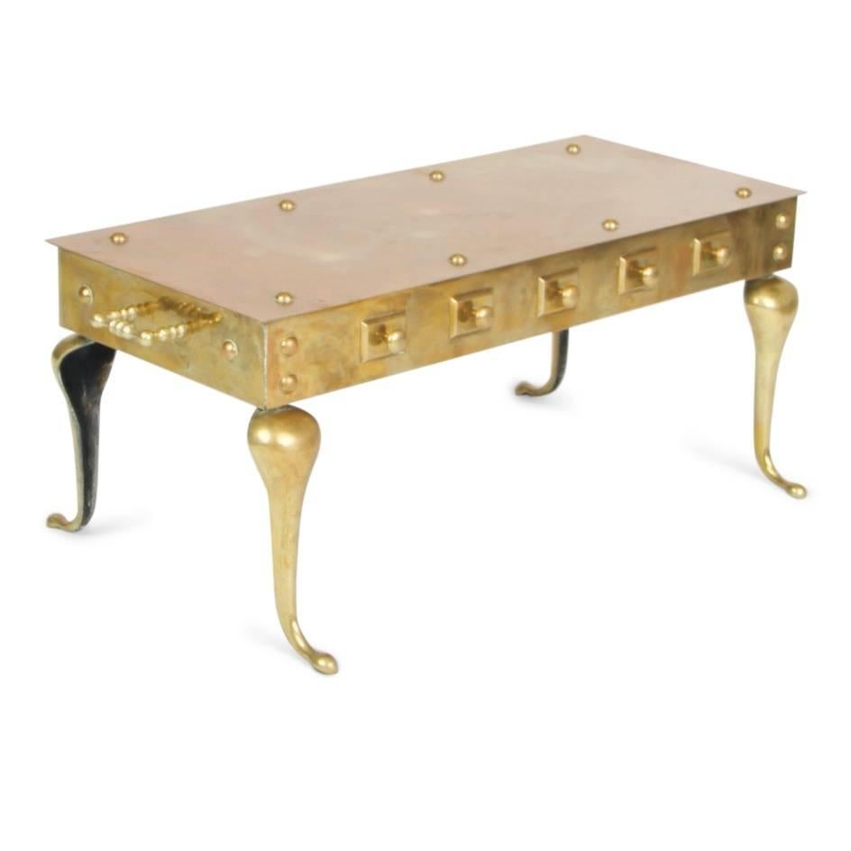 This heavy and substantial English footman bench can be used as both a coffee table or bench. Fabricated from weighty, solid brass this gleaming occasional table features a studded top and sides with handles at either end for ease of relocation.