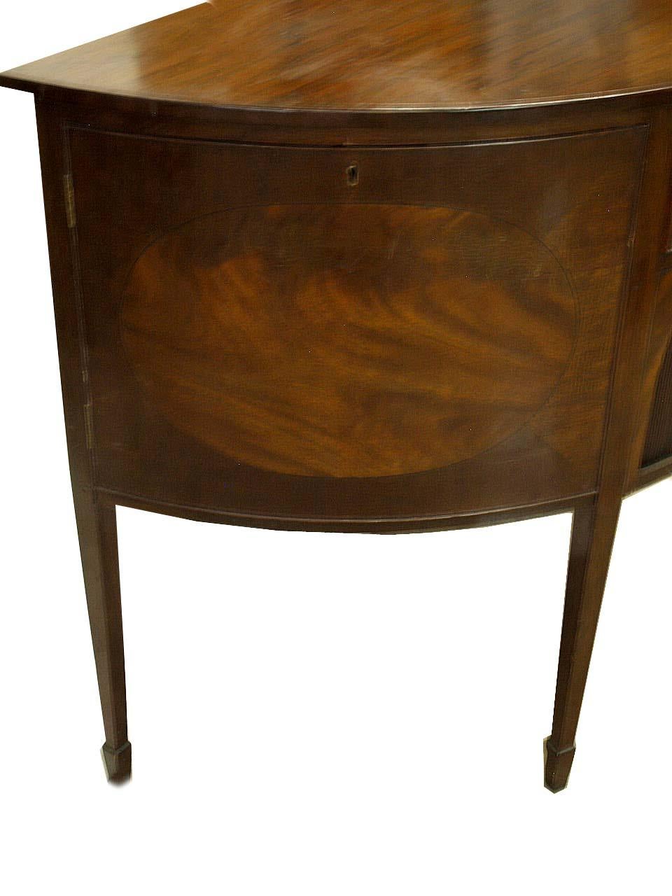English Hepplewhite demi lune sideboard, the top with beautiful grain similar to what is referred to in England as ''plum pudding'', the doors with an oval flame mahogany center surrounded by cross banded mahogany , open interior behind each door.