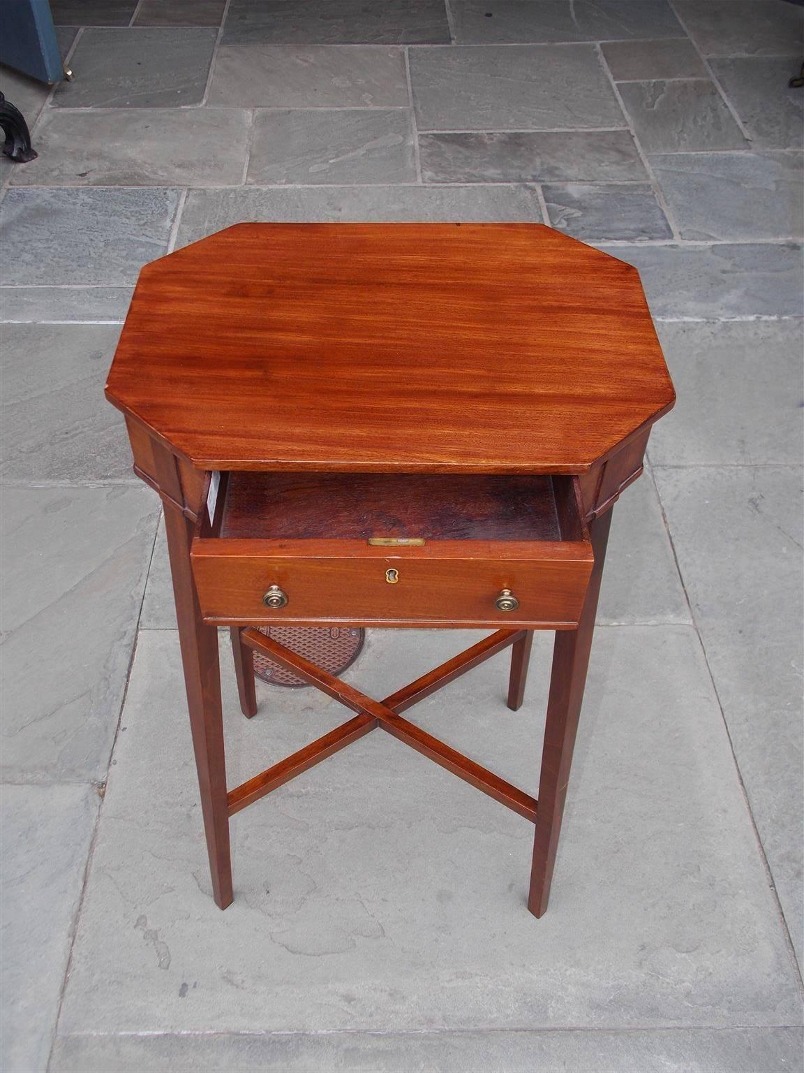 English Hepplewhite mahogany one drawer side table with an octagon carved top, original brass pulls and escutcheon, terminating on tapered squared legs with the original connecting stretchers, Early 19th century. Table is finished on all sides.