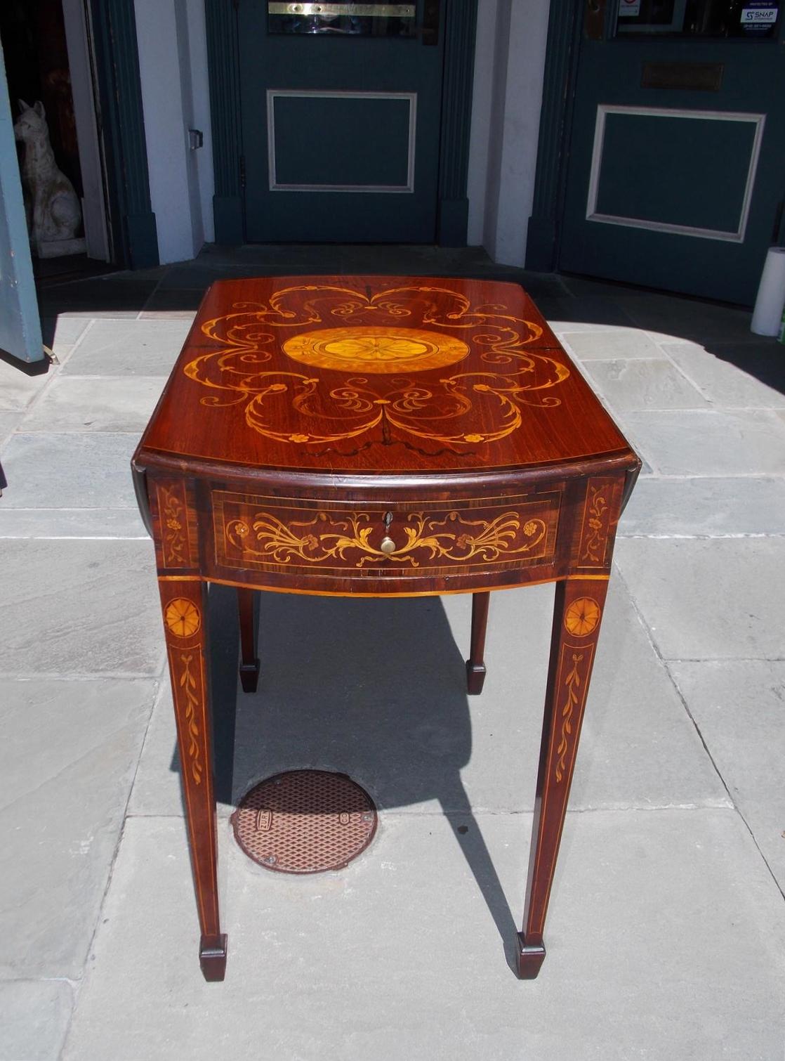 English Hepplewhite mahogany one drawer drop leaf pembroke table with satinwood scrolled floral inlays, cross banded tulip wood inlays, oval patera fan inlays, string inlays, original brass & interior lock, and terminating on tapered squared legs