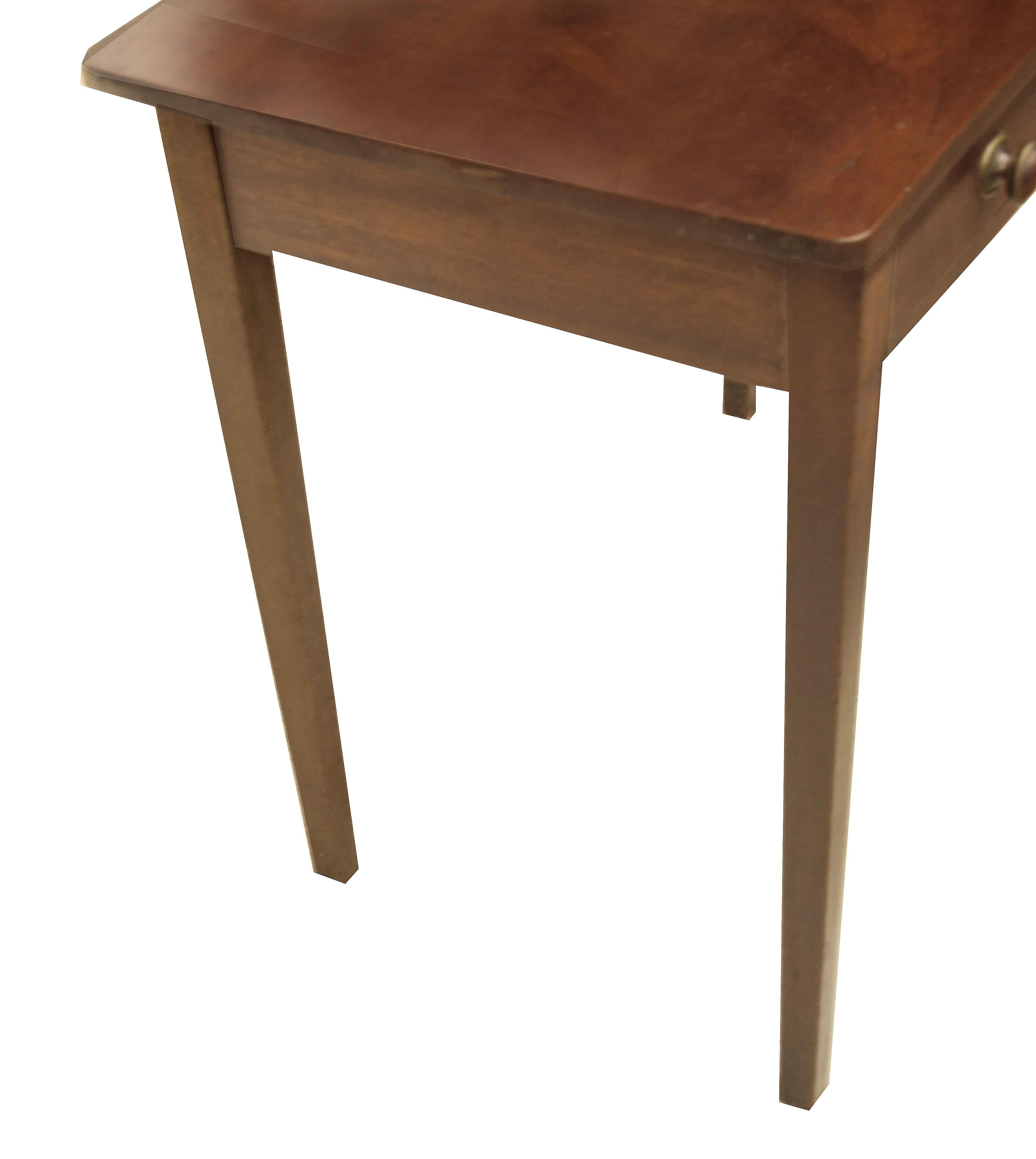 English Hepplewhite side table,  this mahogany table has a beautifully figured one board top.  The single drawer has unusual mahogany knobs encased with brass( they are original).  The legs are nicely tapered.       