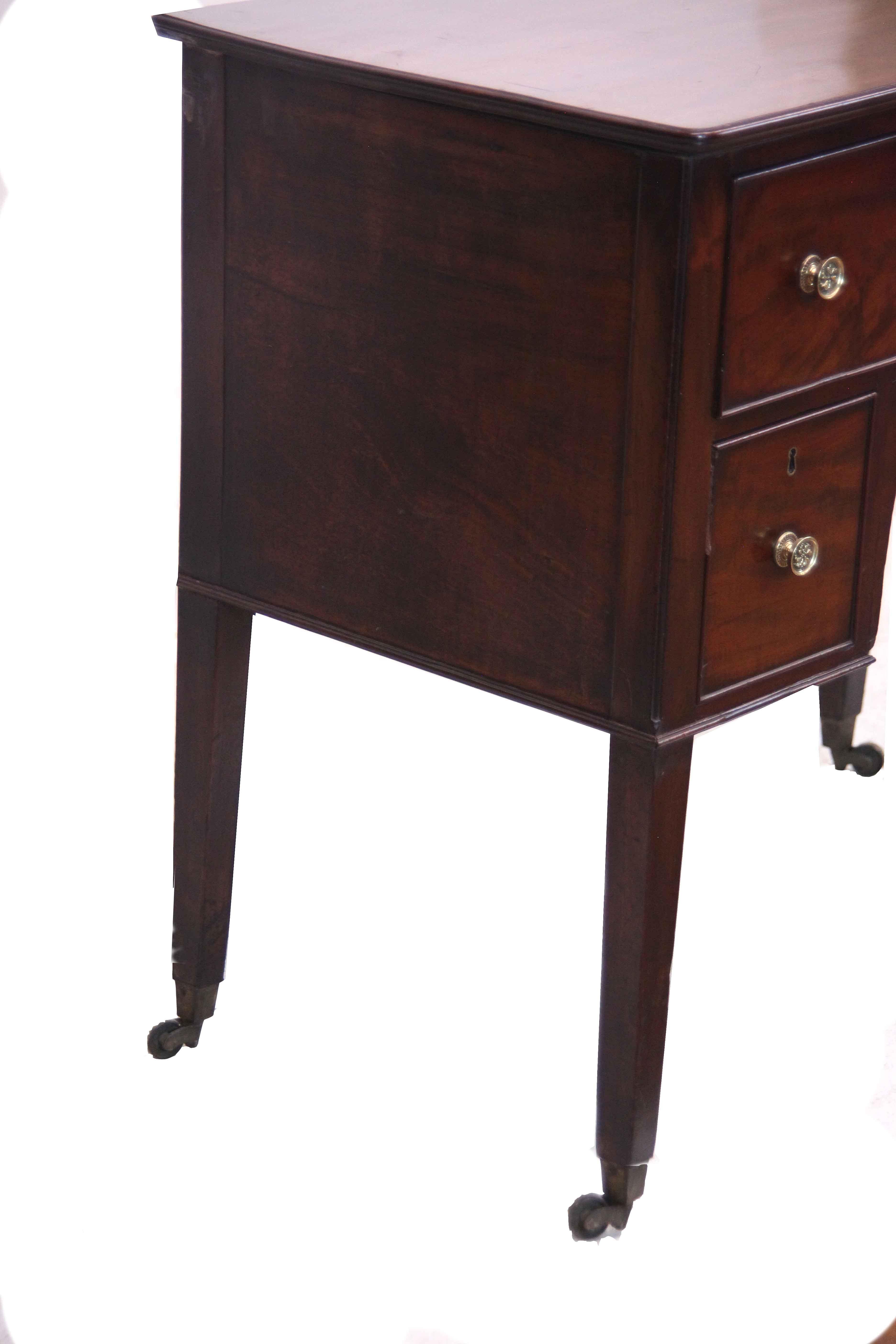 English Hepplewhite small sideboard, with beautiful color and patina, the top with molded edge is above two wide drawers over two square drawers and nicely arched apron.  The tapered legs terminate with brass cup castors.  Note the photo showing the