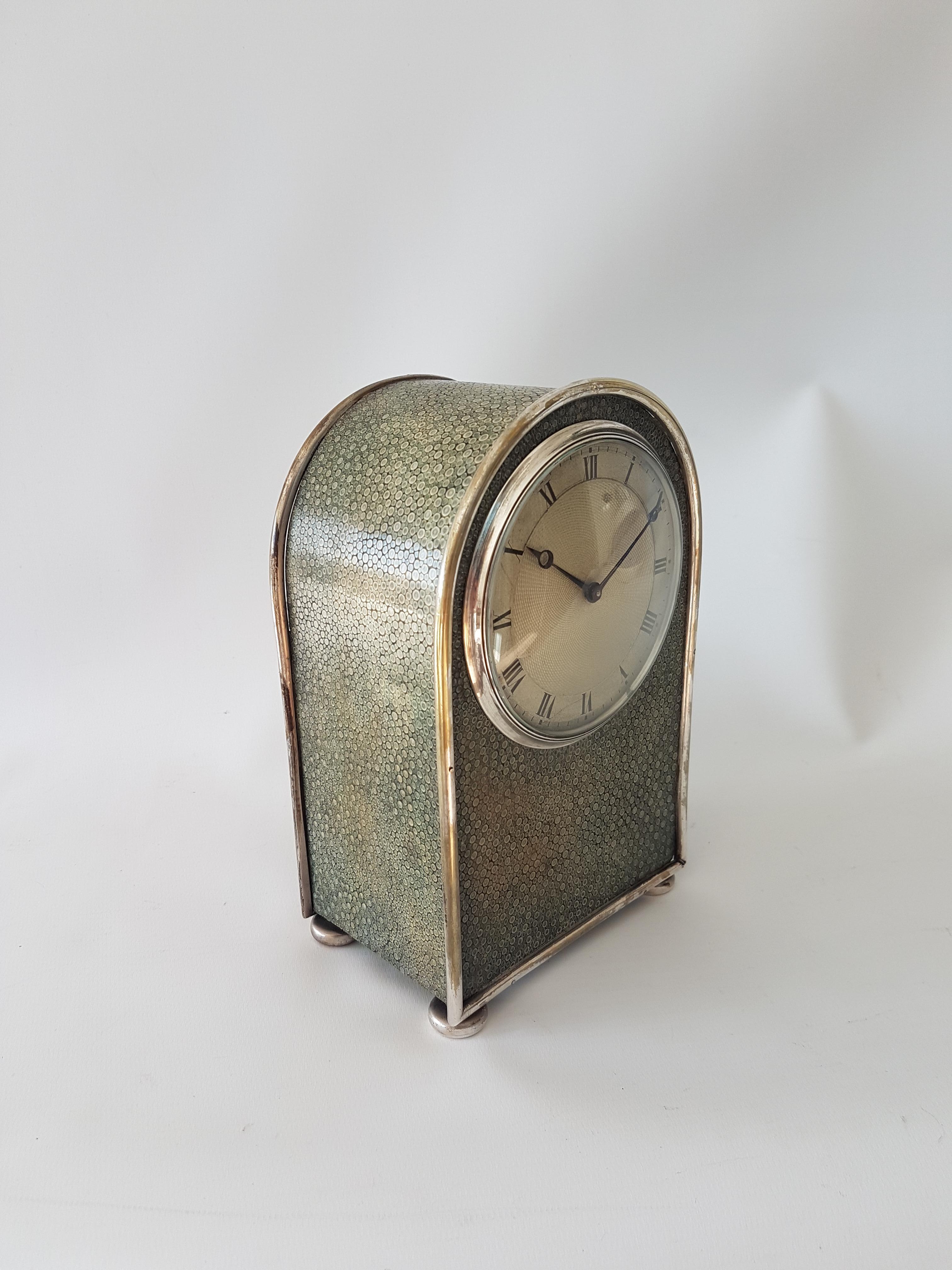 A very fine English late 19th century shagreen & silvered bronze hump backed carriage clock. The nicely proportioned case with fine convex engine turned dial with moon and sitting upon bun feet. The 8 day lever movement numbered. Circa 1895. 7