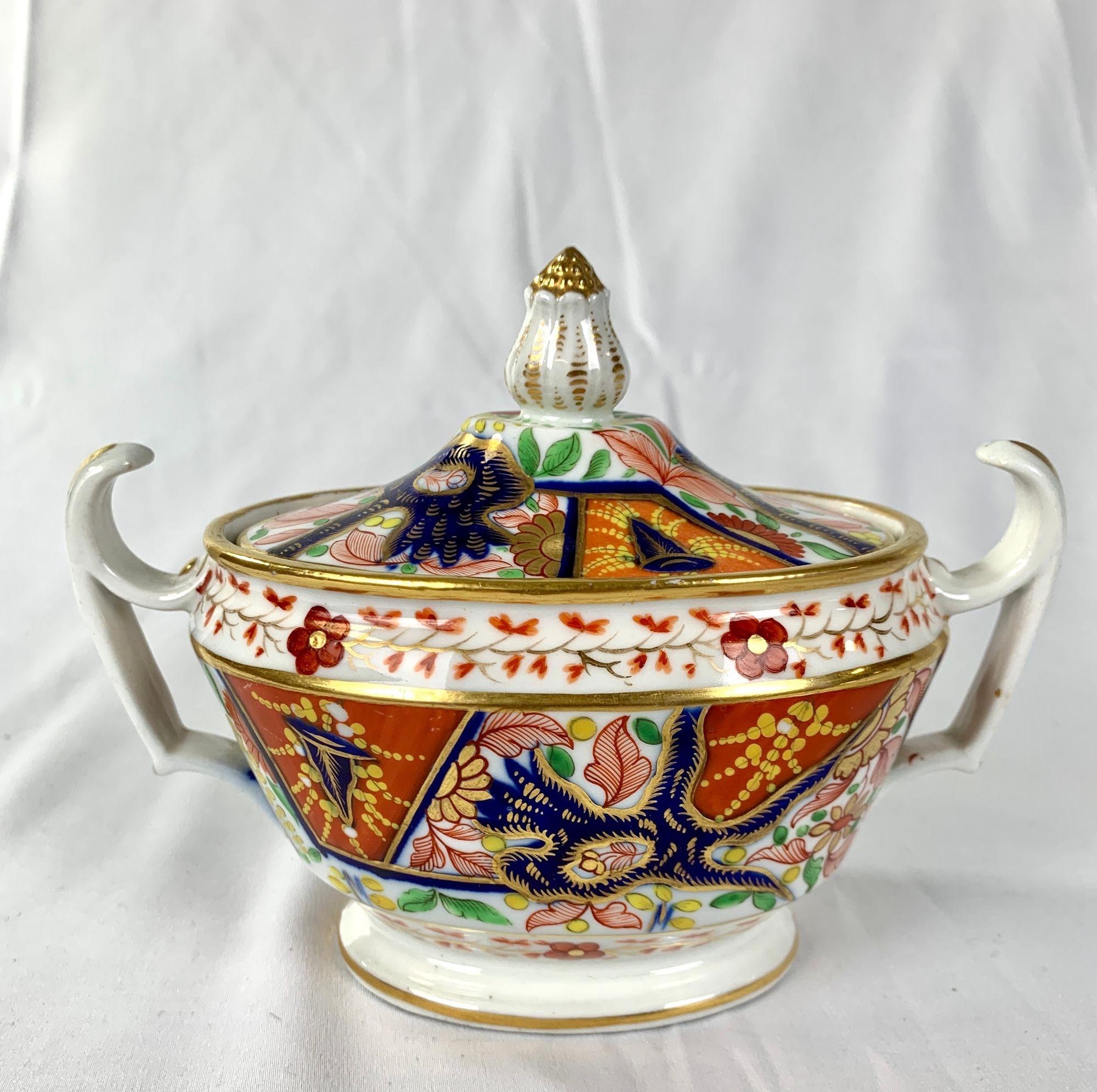 This colorful porcelain sugar box was hand-painted in England circa 1825.                                                                                                                        The exciting design is Imari influenced. The colors seem