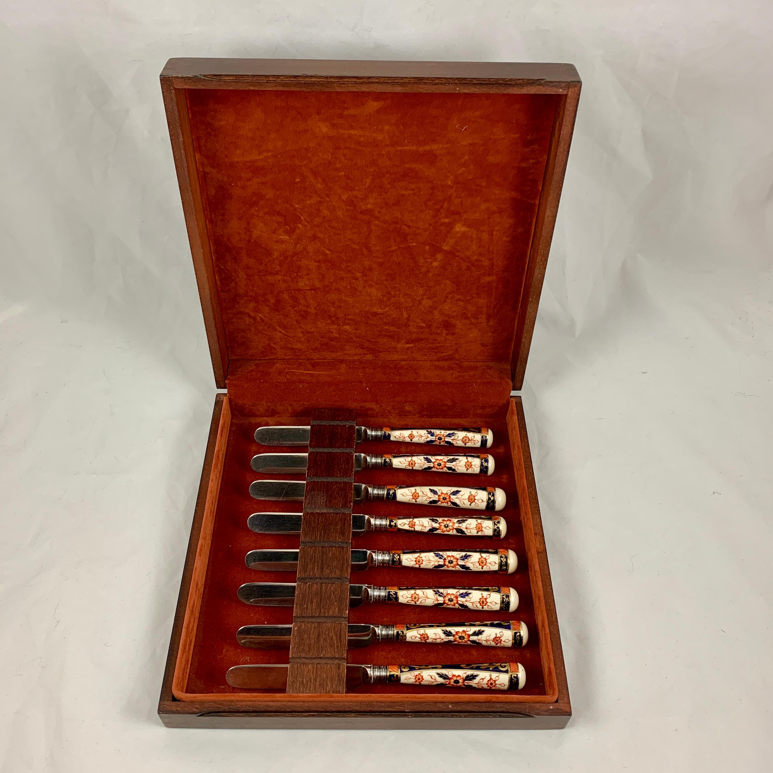 A set of eight English Staffordshire porcelain Imari pattern handled table knives, circa 1860-1870, in the manner of Royal Crown Derby. In the original fitted wood presentation case.

The porcelain handles are transfer printed with a floral Imari