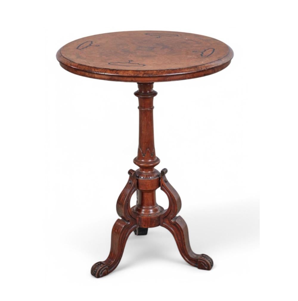 the circular top with demi-bullnose edge all in a richly-colored book-match burl walnut veneer with a satinwood and ebony inlaid perimater band; raised on a turned baluster support with lappet carving the whole raised on burl wood cabriole supports