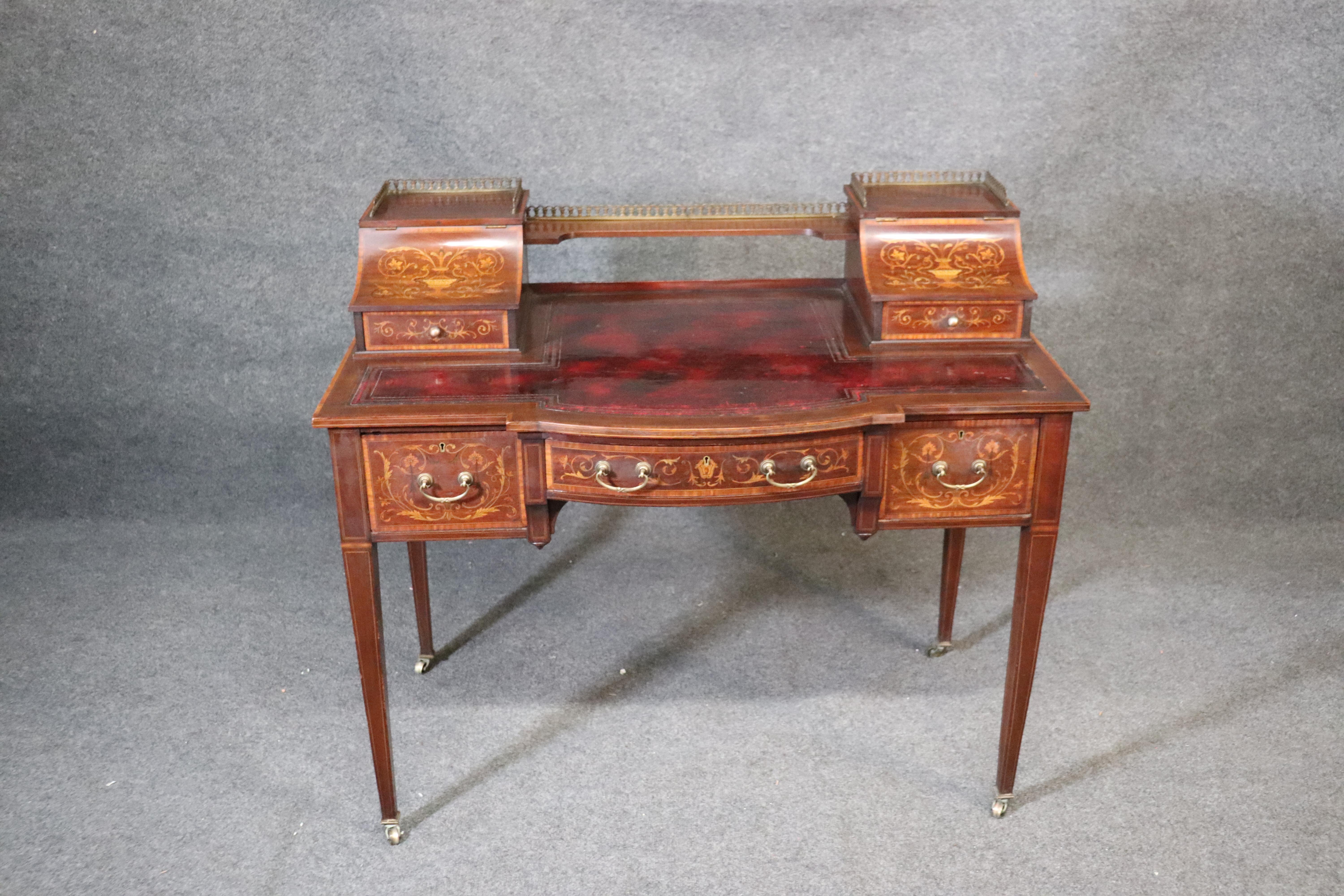 This is a gorgeous inlaid mahogany Edwardian desk. The desk is in good antique condition with minor signs of wear and age as shown. The desk measures: 37 tall x 42 wide x 24 deep.