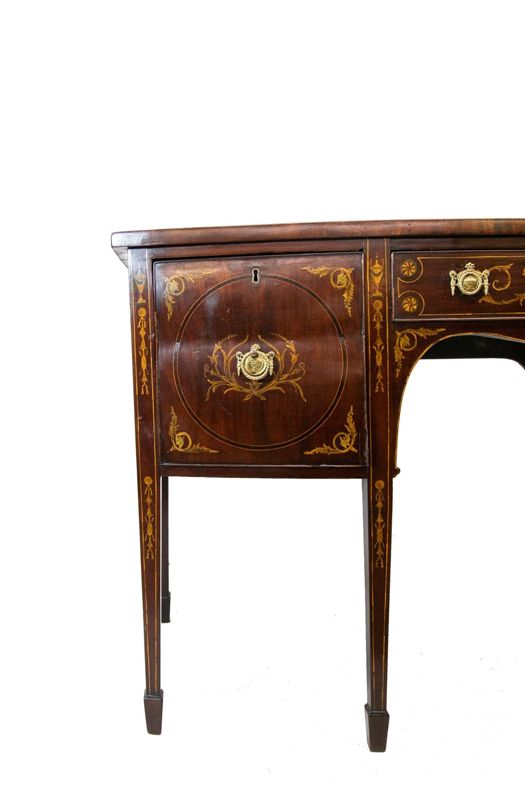 English Inlaid mahogany Hepplewhite sideboard, the top lavishly inlaid with classical urn, floral arabesques, and ribbons. The front is also inlaid with urns. The drawers retain the original keys.
  