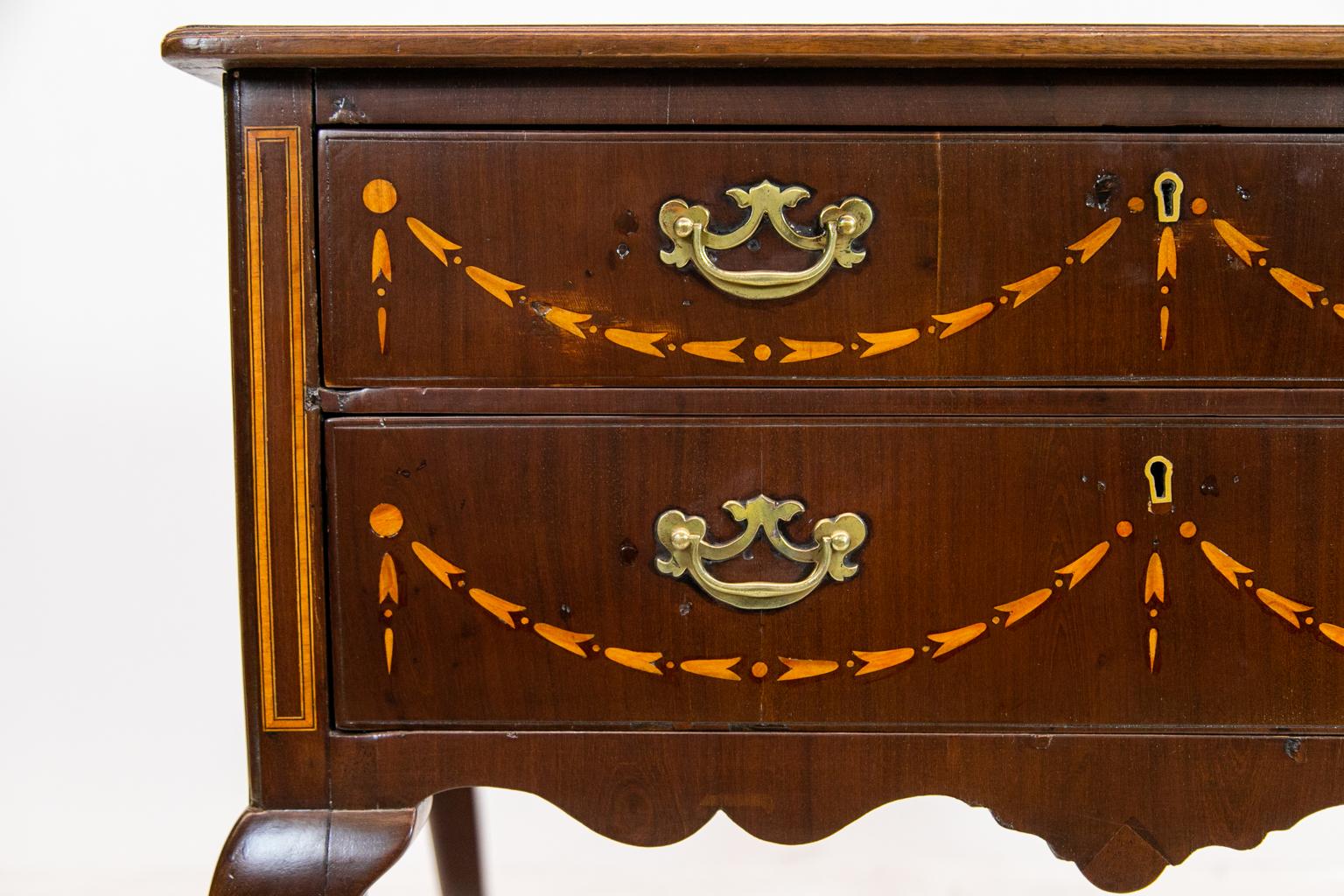 English inlaid mahogany Queen Anne lowboy with neoclassical inlaid bellflower swags, satinwood crossbanded top, and ebony and boxwood line inlay. There is satinwood crossbanding on the sides.