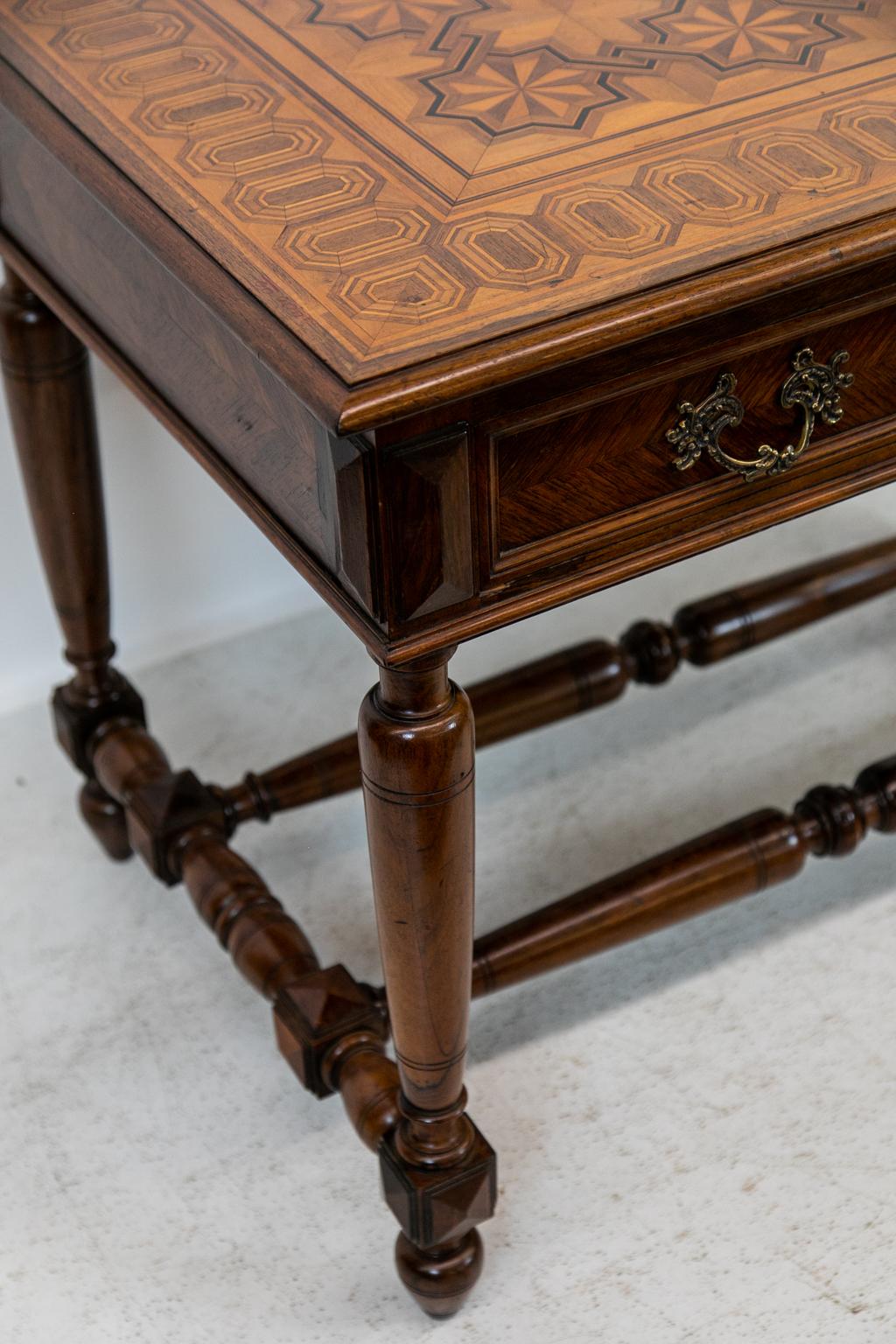 English inlaid one-drawer side table, top intricately inlaid with geometric interlacing patterns of ebony, boxwood, and satinwood. All three panels and drawer front have rosewood herringbone bookmatched fronts. The turned legs are joined by double