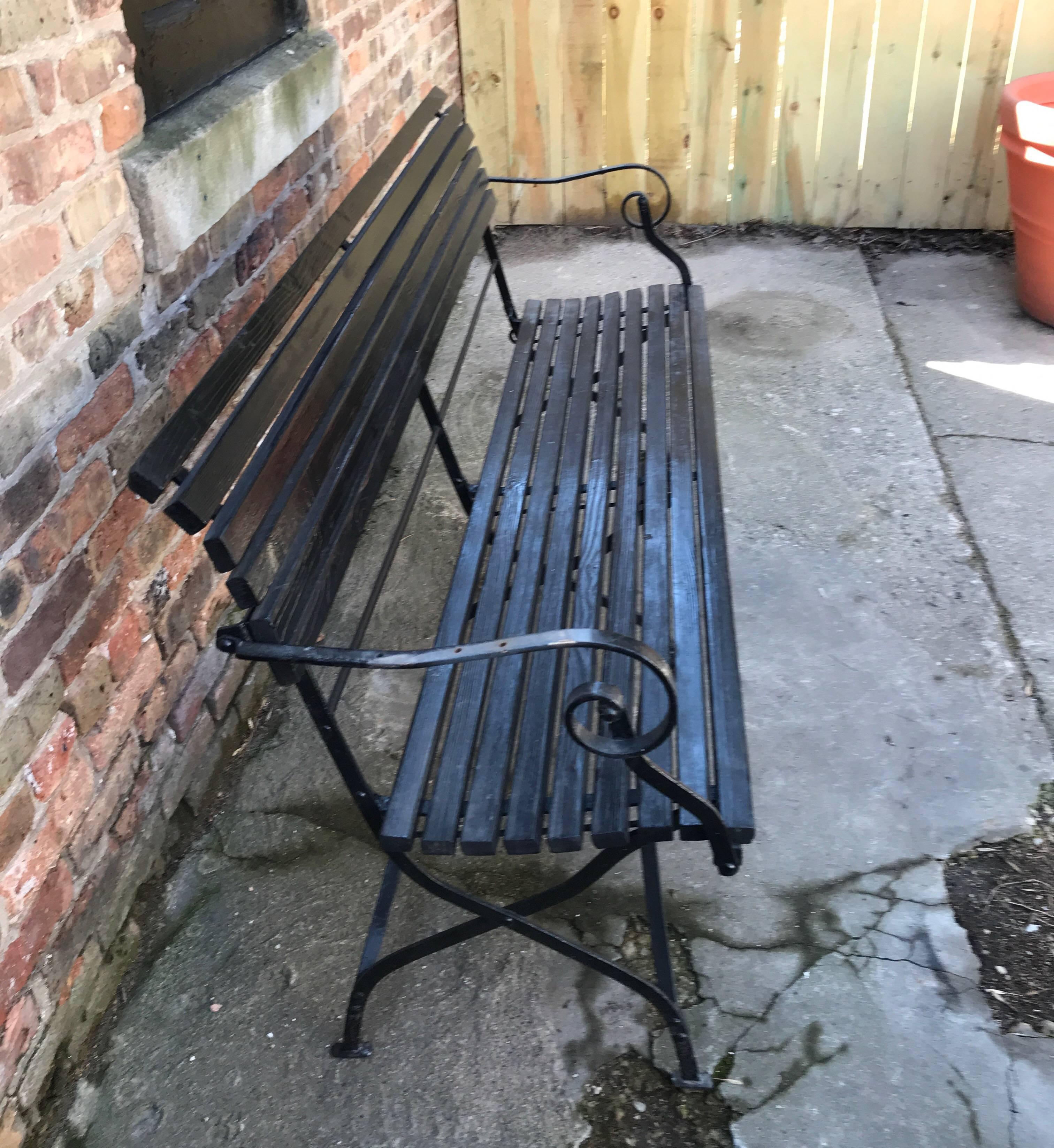 A versatile late Victorian English wood and iron folding garden bench.