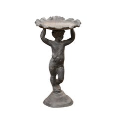English Iron Greco-Roman Style Standing Cherub Carrying a Sea Shell Bird Bath