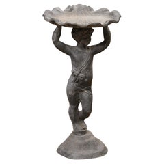 Used English Iron Greco-Roman Style Standing Cherub Carrying a Sea Shell Bird Bath