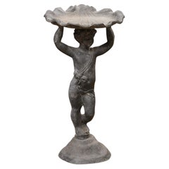 Retro English Iron Greco-Roman Style Standing Cherub Carrying a Sea Shell Bird Bath