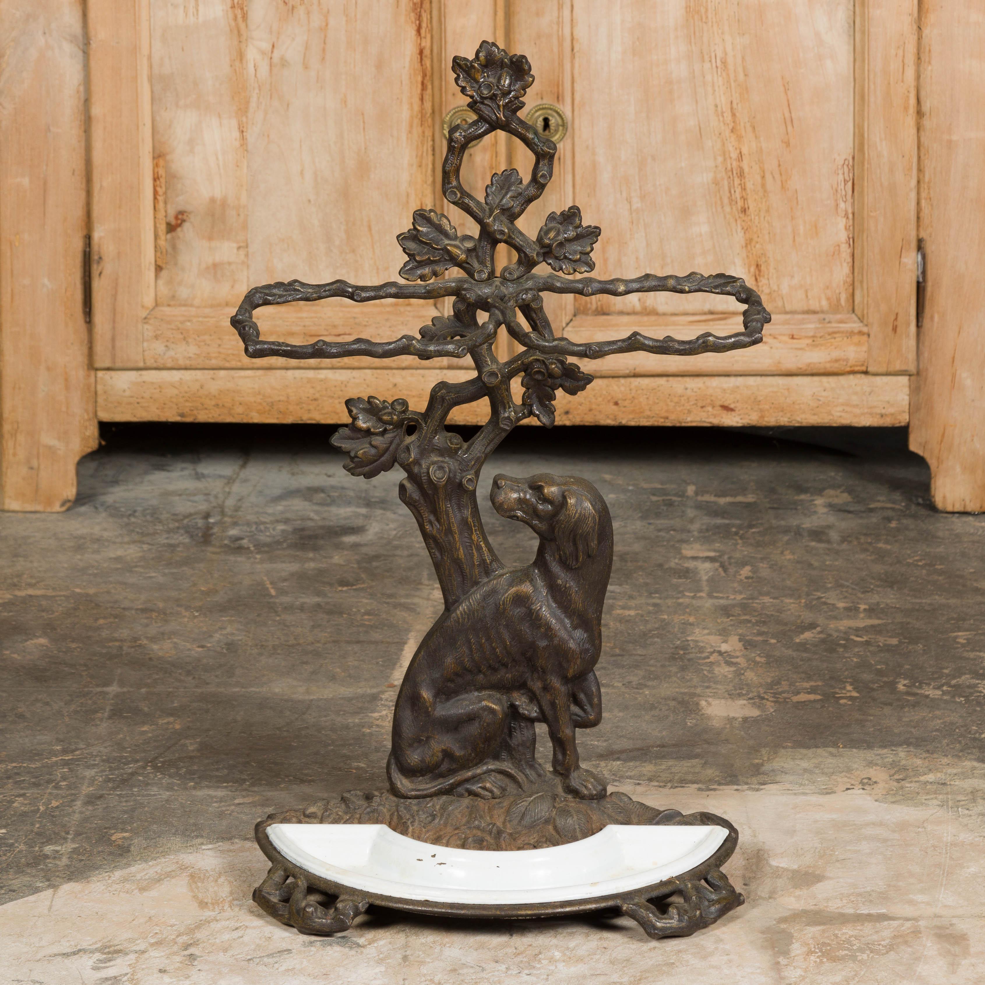English Iron Umbrella Stand with Dog and Tree Motif and White Receptacle In Good Condition For Sale In Atlanta, GA