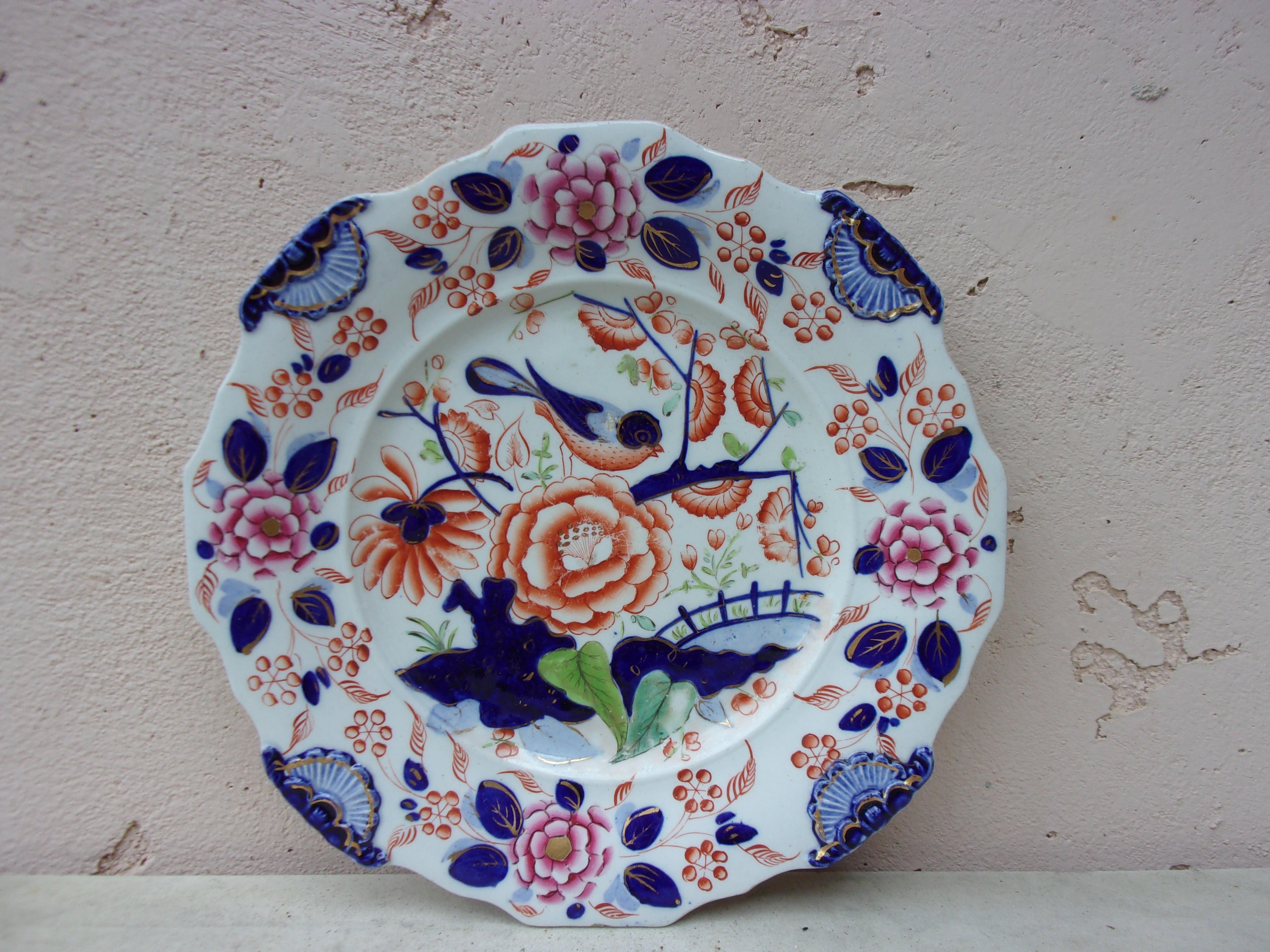 English ironstone plate circa 1890.
Chinoiserie or Imari style, decorated with flowers and a bird.
