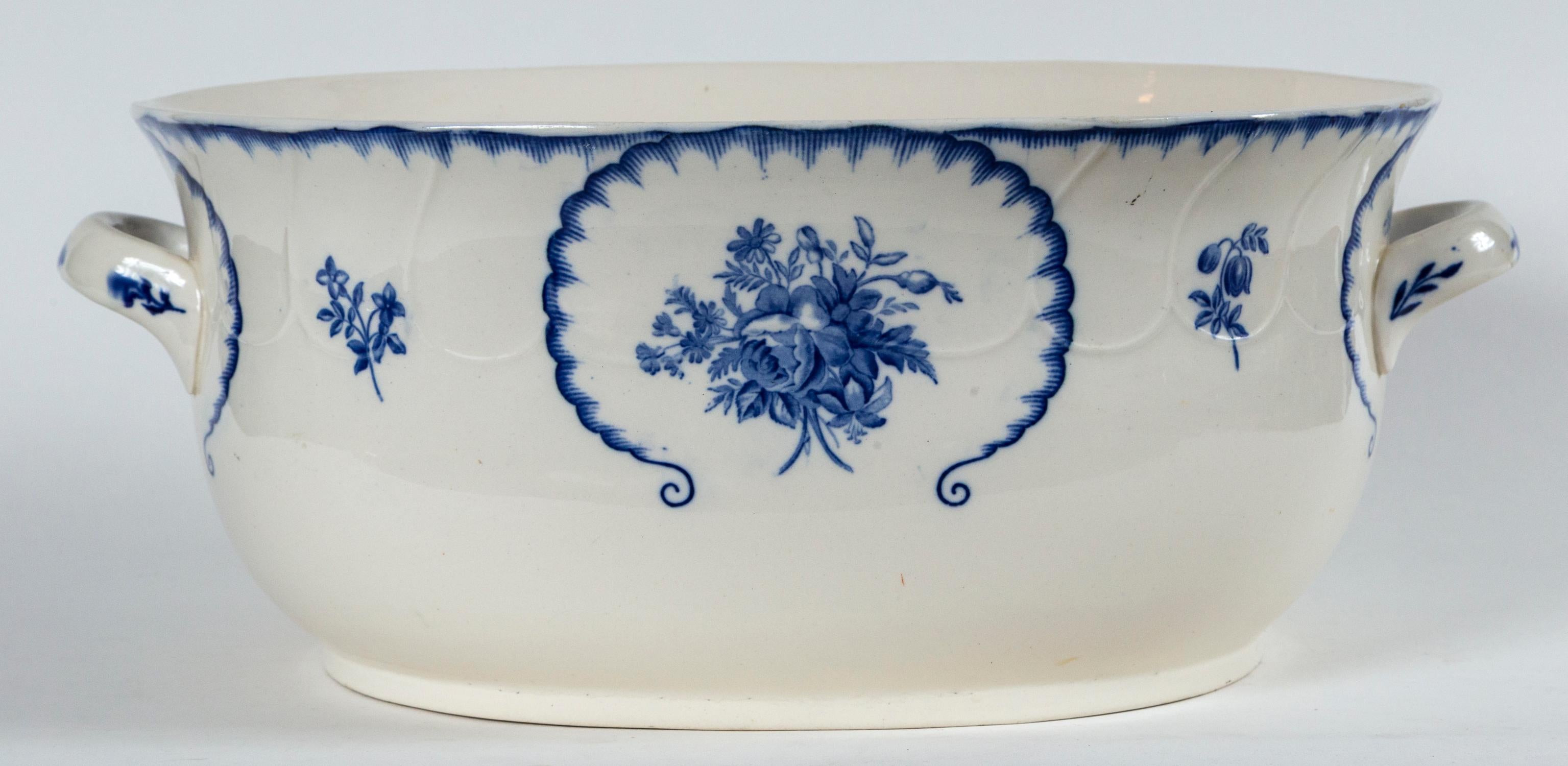 English ironstone foot bath, late 19th century. Blue floral transferware design on white ground. Oval shape with 2 handles. Marked on bottom. A great display piece.
 