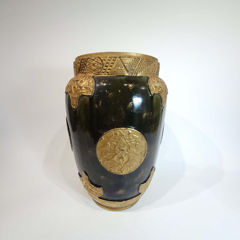 This a wonderful and rare English pottery vase in Persian motif mimicking an ancient glass vase with gold appliques.
Circa late 19th century with irridescent greenish glaze, with a blue hue.
 