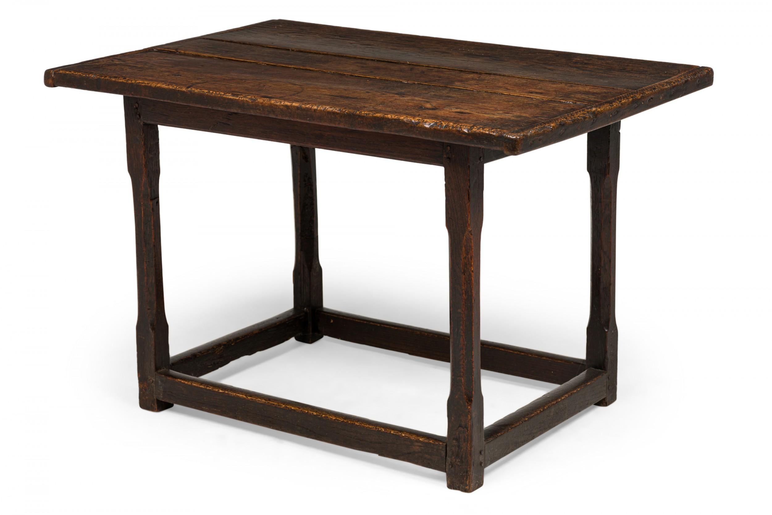 English Jacobean (17th Century) rectangular rustic oak table with 3-plank overhanging top, incised legs with a box sretcher and a fine finish enhancing the grain.

Dark circular marks and wear.