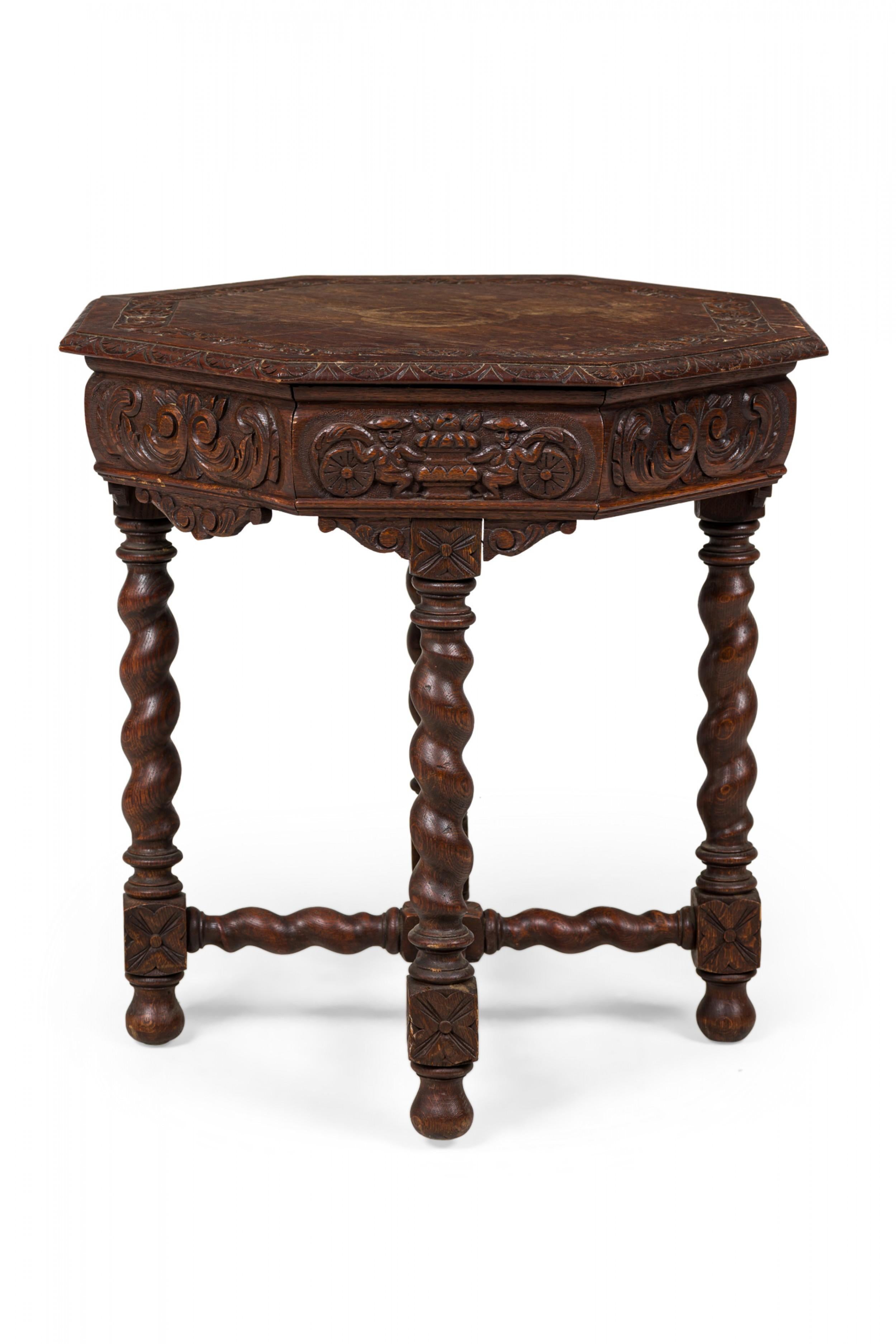 English Jacobean-style carved oak occasional / side table with an octagonal top with carved inlay and apron, resting on four spiral turned legs joined by a spiral turned x-stretcher and resting on carved ball feet.