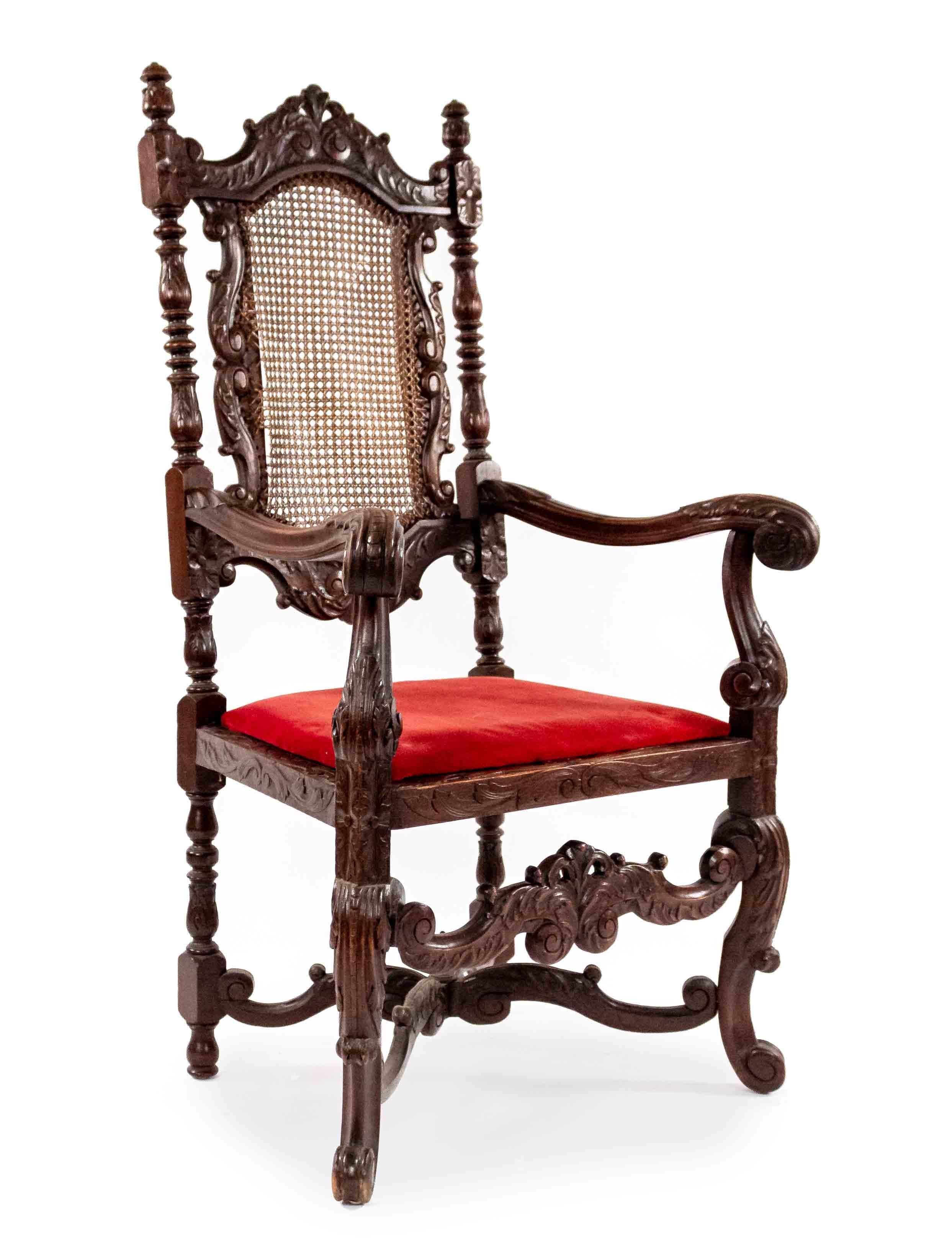 Pair of English Jacobean style (19th century) walnut arm chairs with cane seat and back and finial on stretcher.