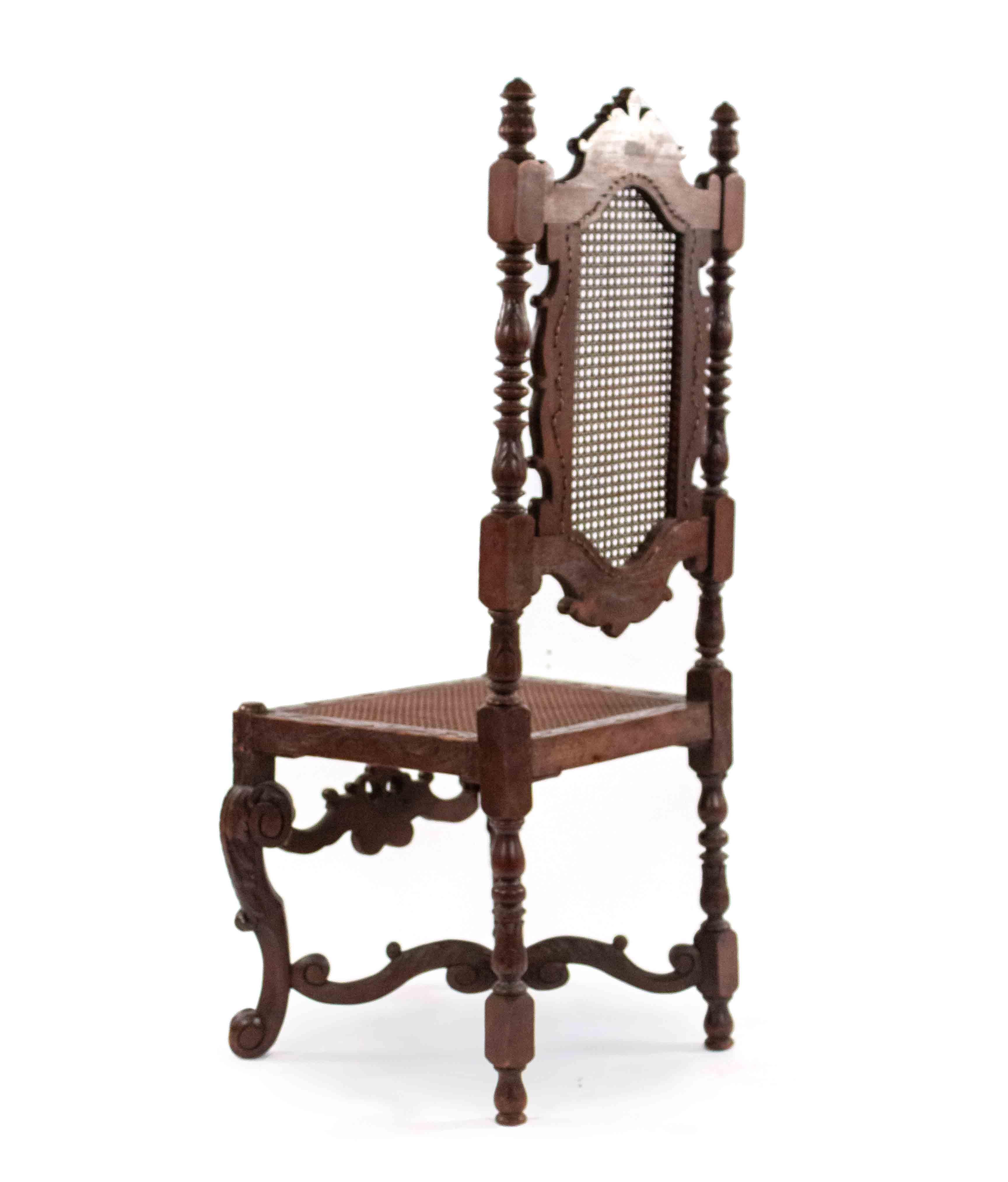 Pair of 19th century English Jacobean-style walnut side chairs with cane seat and back with finial on stretcher.