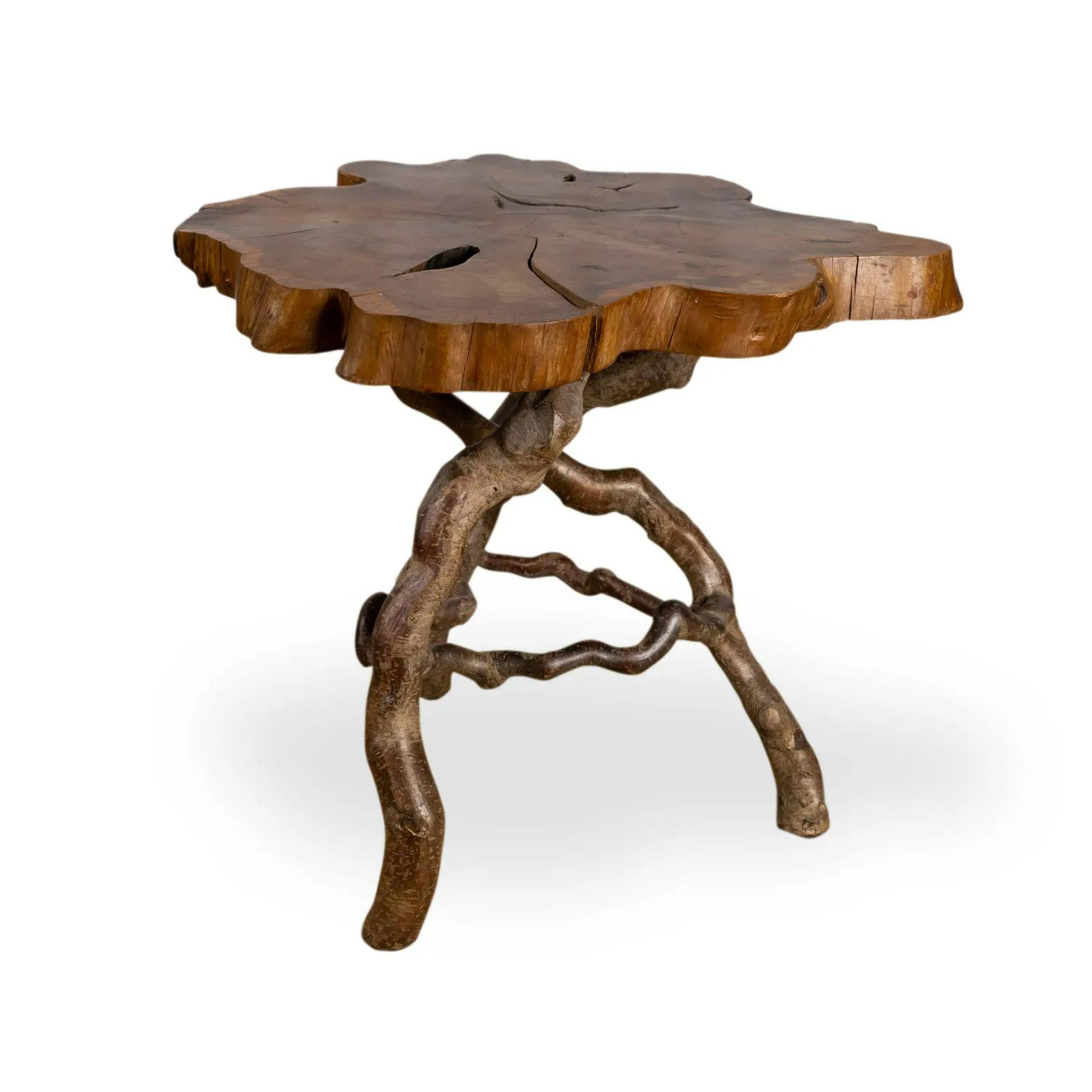 English Laburnum root wood table, Early 20th Century

A charming rustic laburnum-wood occasional table. The polished top rests on a later stick-base retaining its natural bark. 

Dimensions: H 47cm x D 53cm x Dia. 65cm.