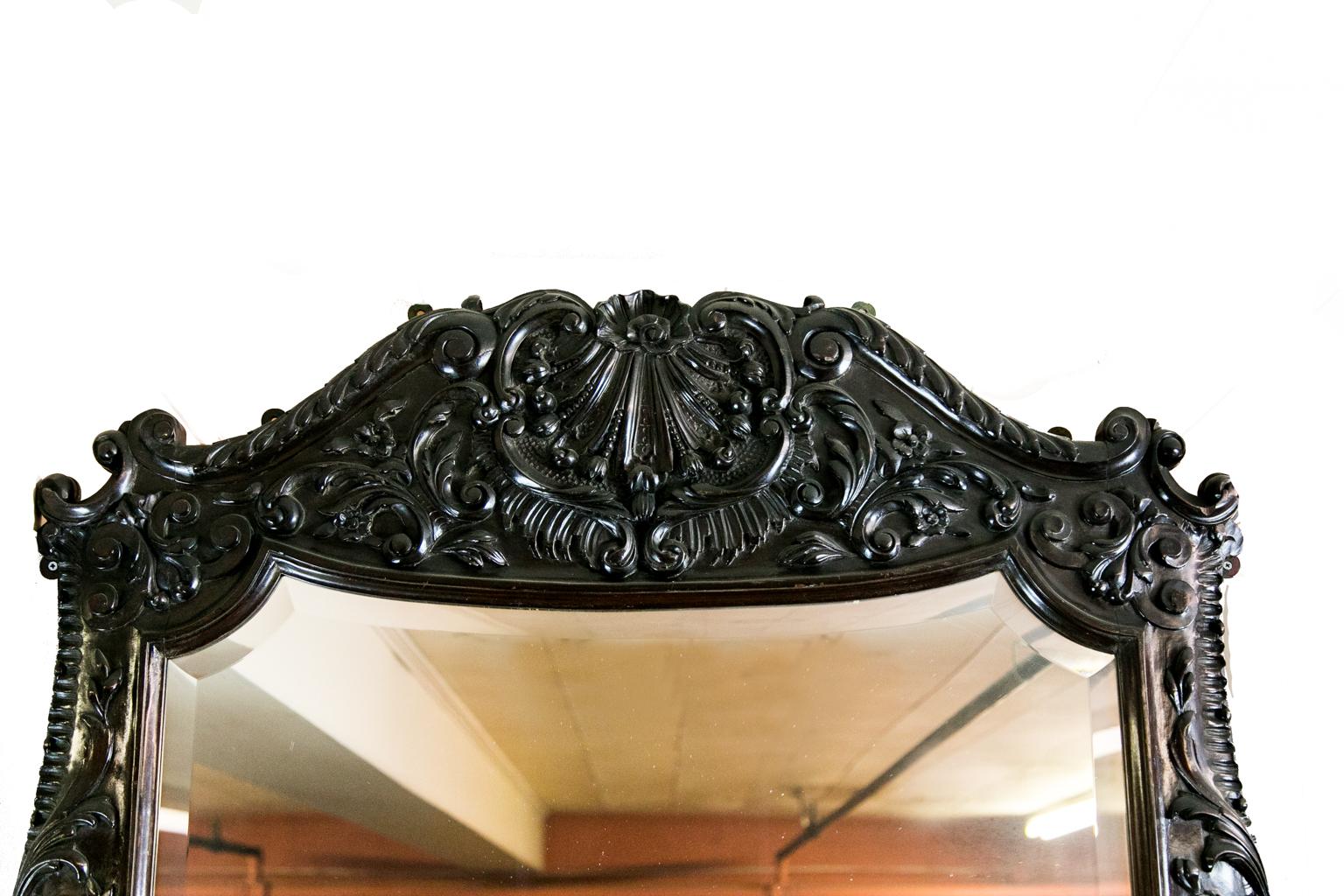 English large carved beveled mirror, the frame carved in deep relief in floral and arabesques motifs. This mirror can also be hung horizontally.