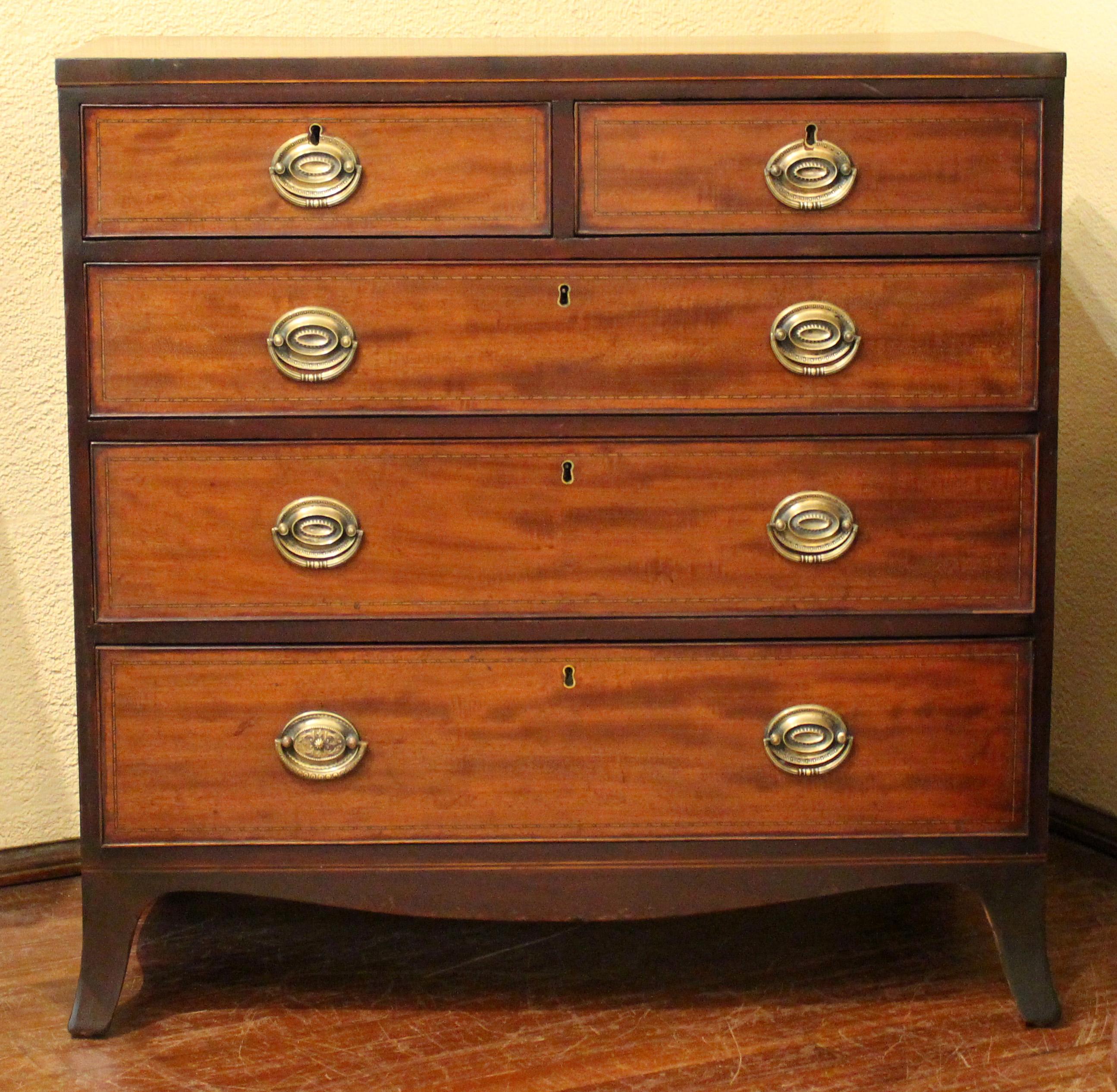 Georgian straight front chest of drawers, two short over three long, raised on French splay feet, shaped aprons. Mahogany with pine secondary wood. English, late 18th century. Caddy top with line inlaid edge. Drawer fronts with barberpole motif