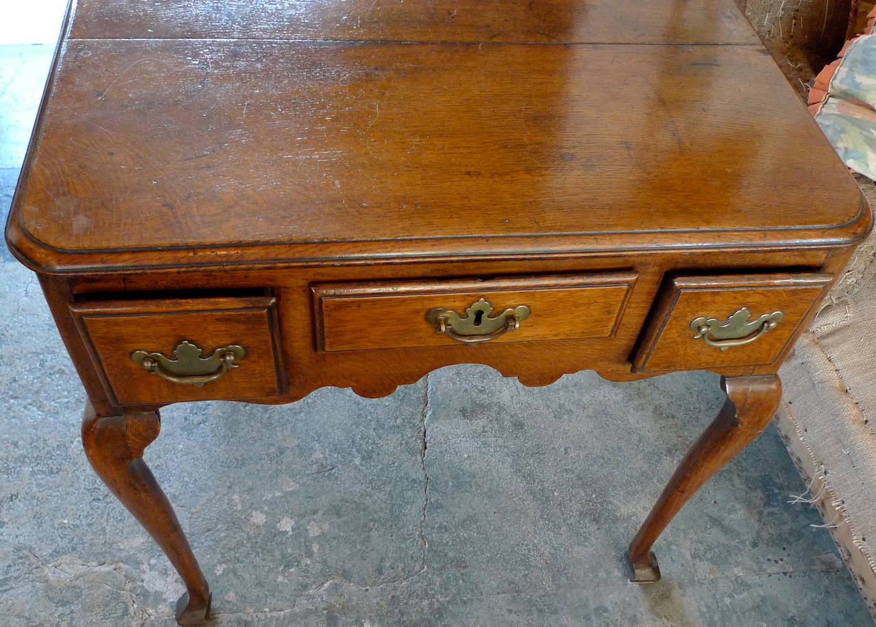 English late 18th century Queen Anne low-boy end table with three small drawers.