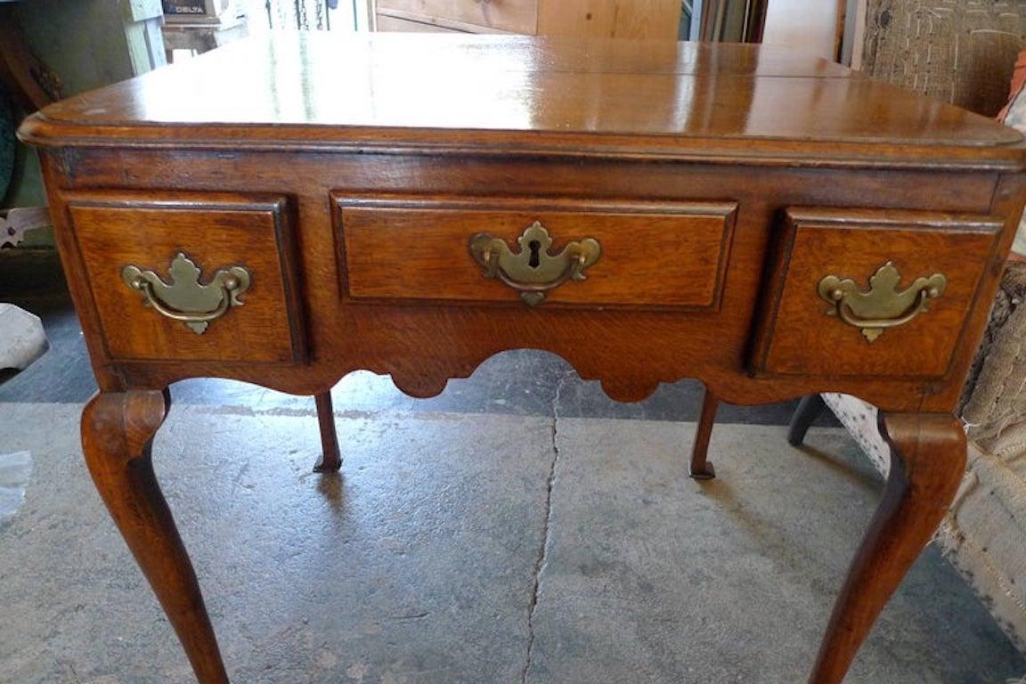 English late 18th century Queen Anne low-boy end table with three small drawers.