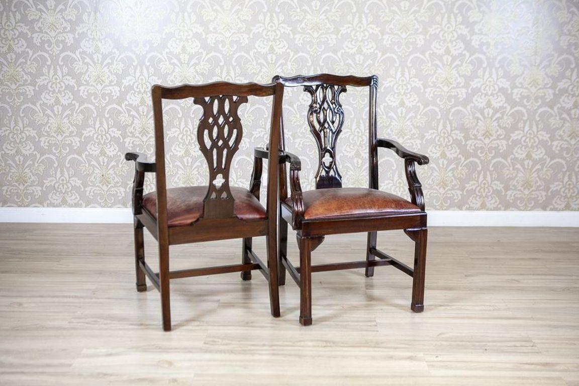 English Late-19th Century Four Walnut Chairs With Leather Upholstery 

A set of four chairs made of walnut wood, with seats crafted from leather. The chair backs feature an openwork element, adding visual lightness to the structure, and the seat