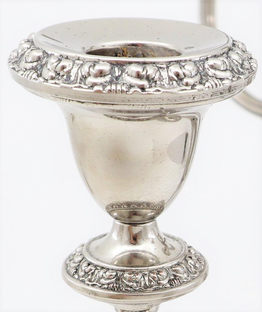 English late 19th-early 20th century silver-plated five-light candelabra. The candelabrum is in the neoclassical taste and rests on a circular two-tiered base adorned with a flower border.
The pieces are hallmarked with the following: “Silver-plated