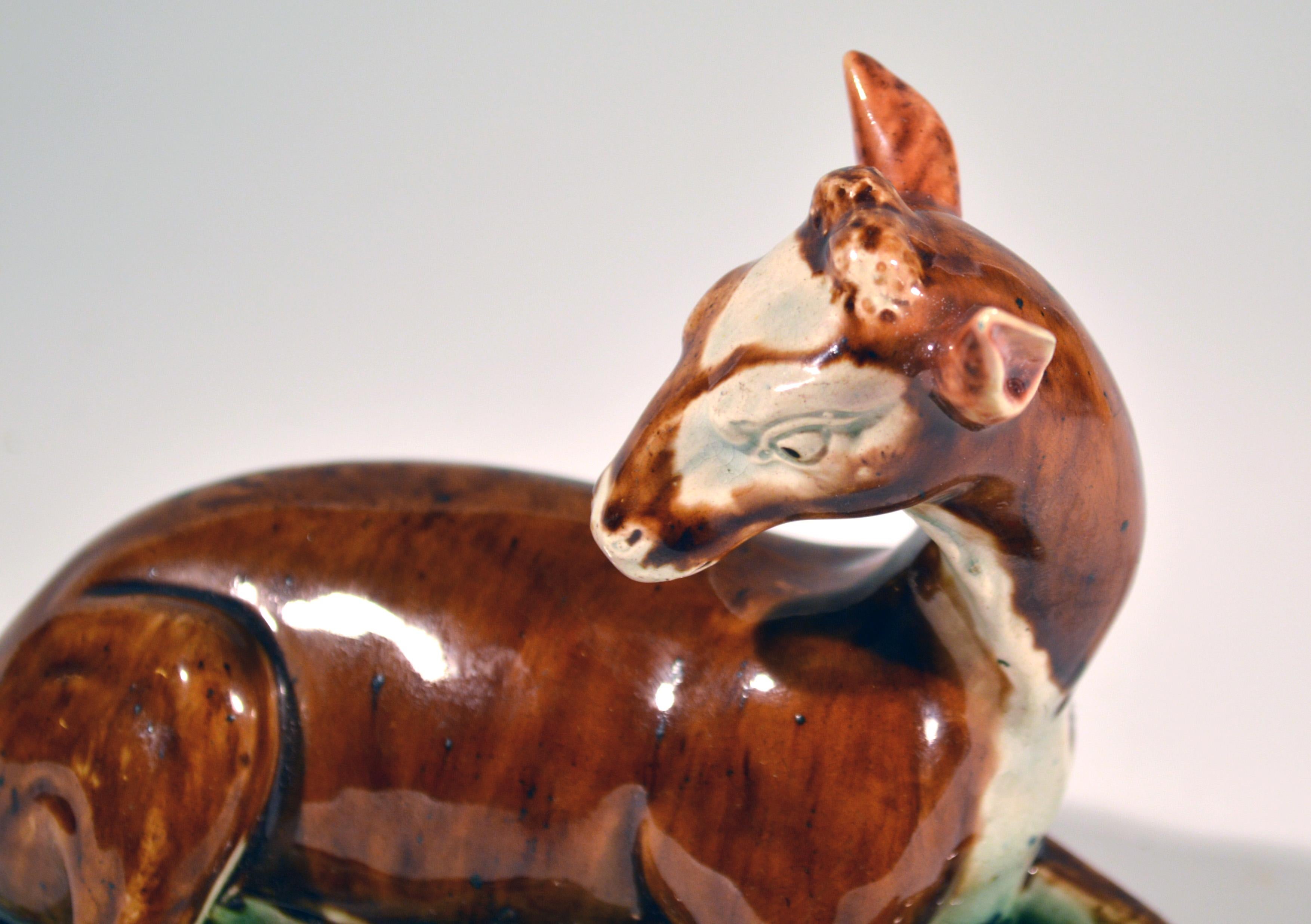English lead-glazed earthenware model of a Doe at Lodge, 
Wood type,
Perhaps John Wood of Brownhills or Ralph & Enoch Wood of Burslem,
circa 1785

A fine example of this press-moulded model of a doe with a rich deep brown coloration to the