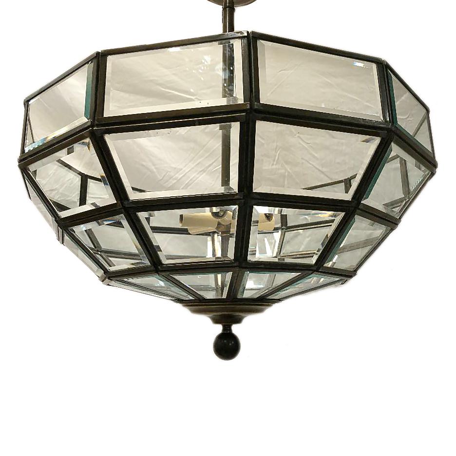 A circa 1940s English patinated bronze and clear glass semi flush-mounted light fixture with interior lights and original patina.

Measurements:
Width 22”
Height 26”.
