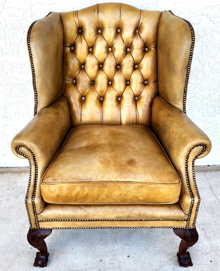 For FULL item description click on CONTINUE READING at the bottom of this page.

Offering one of our recent Palm Beach Estate fine furniture acquisitions of an
early 1900s traditional English wingback chesterfield leather armchair
Set on 4 ball and