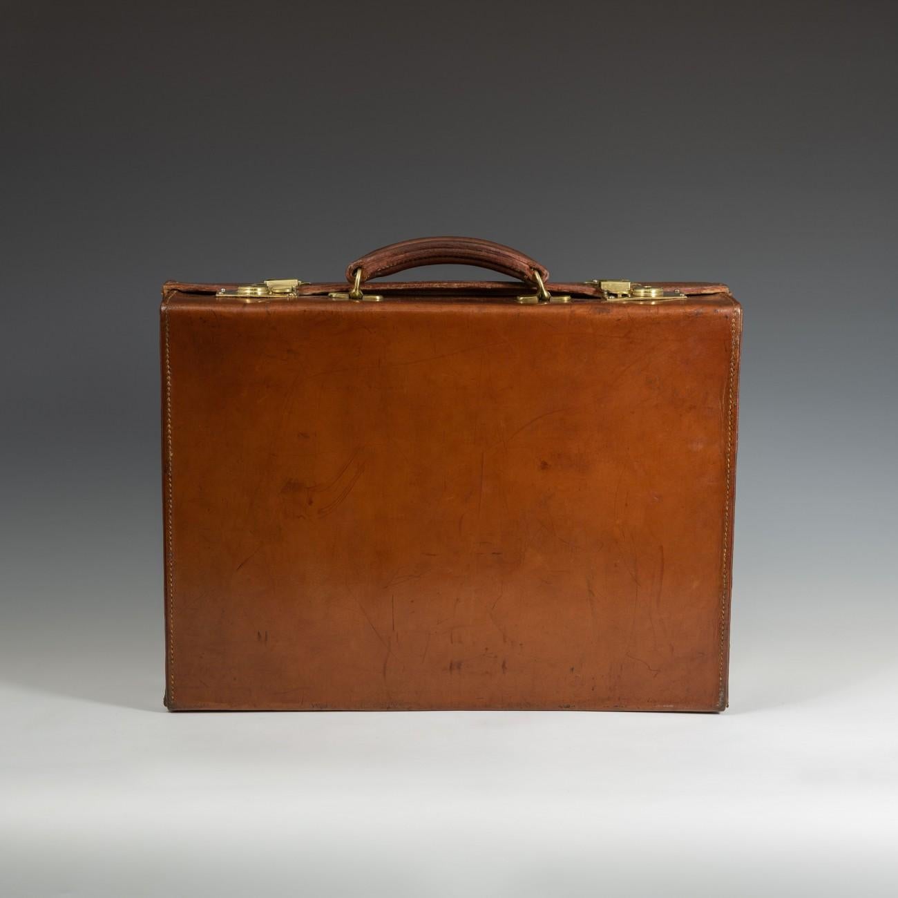 A splendid English leather attaché case with cast brass fittings, circa 1940. The briefcase has a new fabric lining to the interior.

Dimensions: 45.5 cm/17? inches x 34 cm/13? inches x 12.5 cm/4? inches

Bentleys are Members of LAPADA, the London