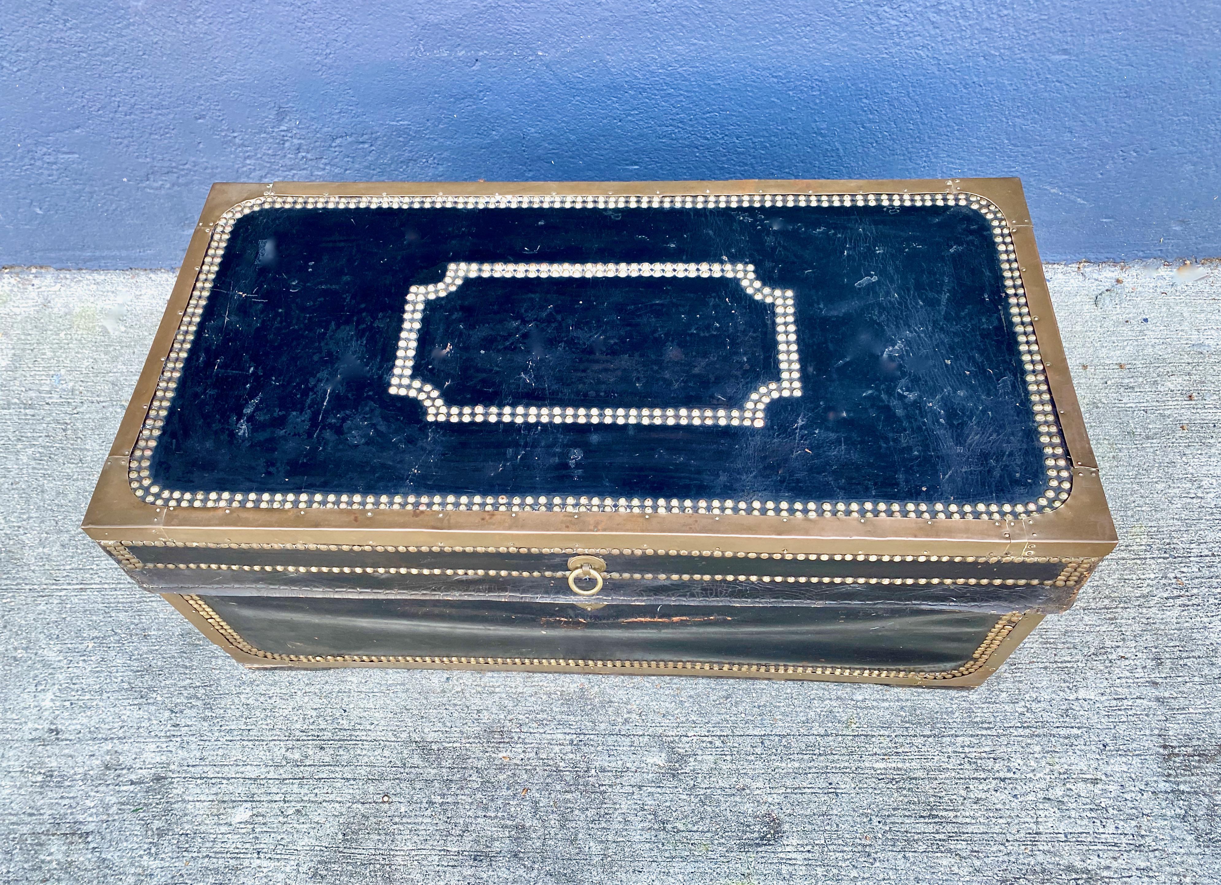 This is a classic British leather-bound Campaign Trunk that was created in China at the beginning of the 19th century. The trunk is constructed of camphor wood; leather bound and detailed in brass nail heads. The trunk retains its original surface