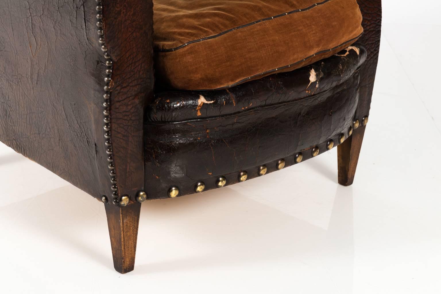 English leather club chair with velvet cushion and oversized nailhead trim, circa 1890.
 